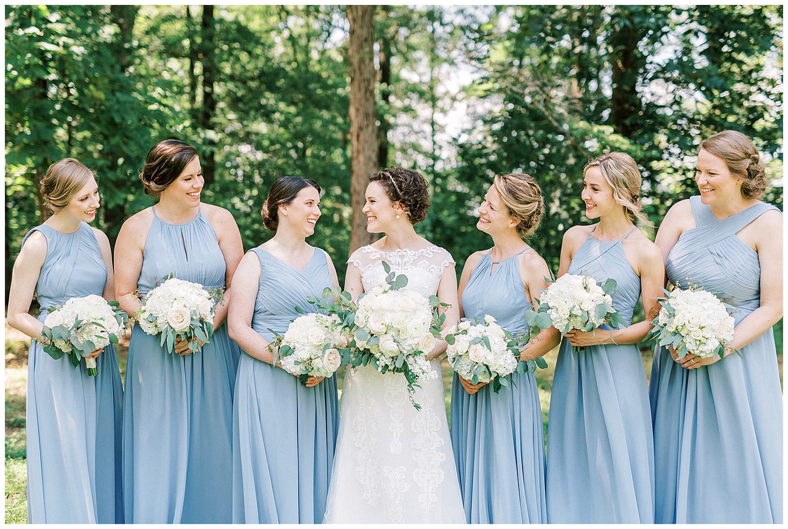 dusty blue bridesmaid bride tribe with white flower bouquet summer outdoor group photo