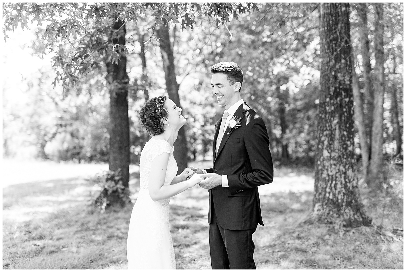 outside groomsmen first look of curly short haired bride with lace wedding dress