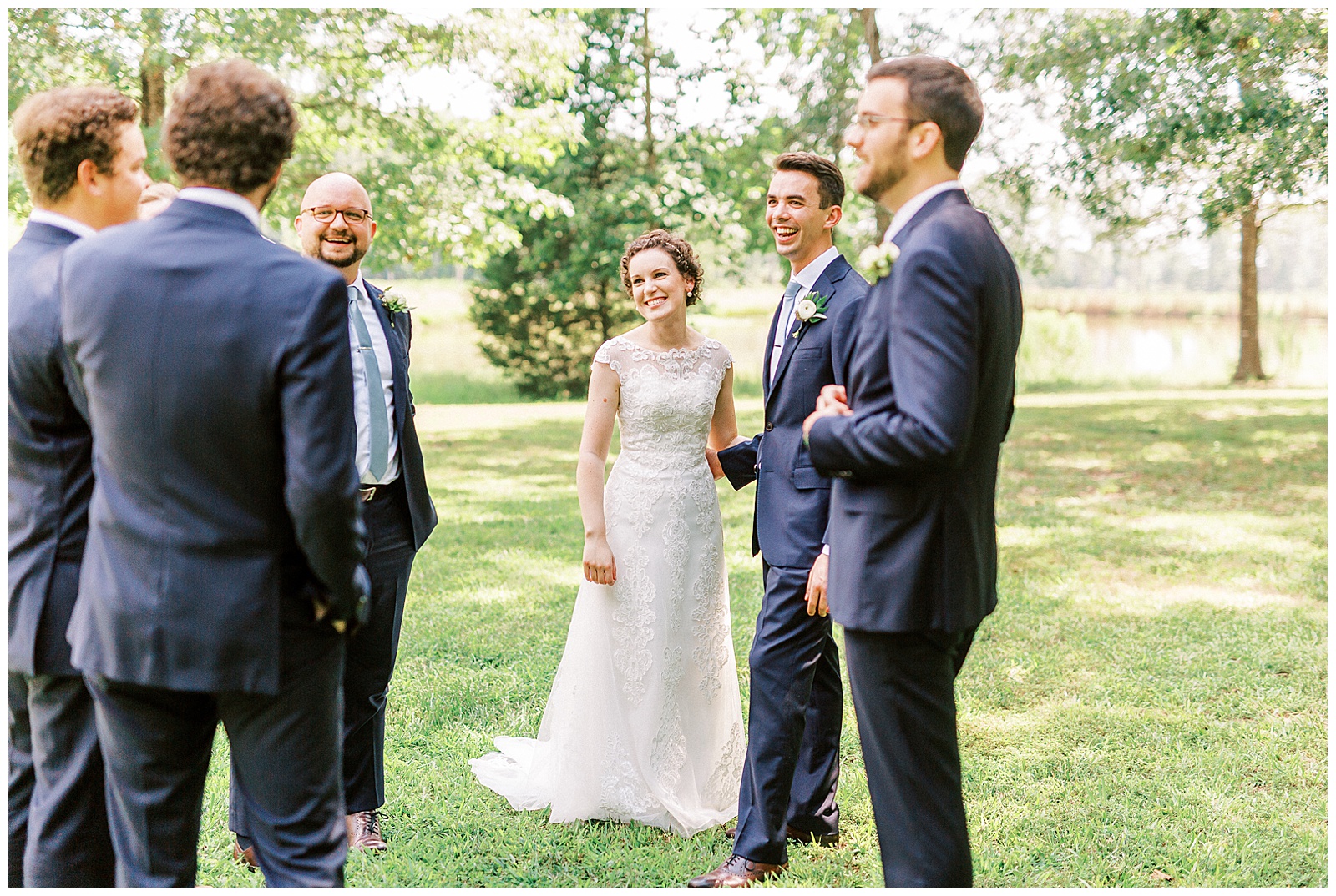 outside bride groom wedding day portraits curly short haired bride with lace wedding dress and navy blue suit groom