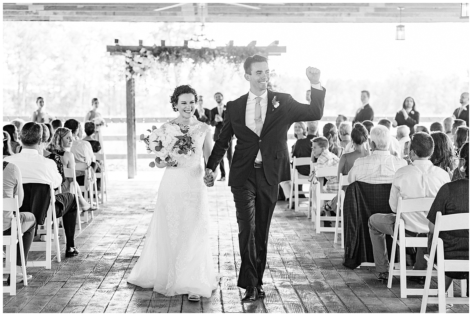 bride and groom exit summer wedding ceremony wave at guests
