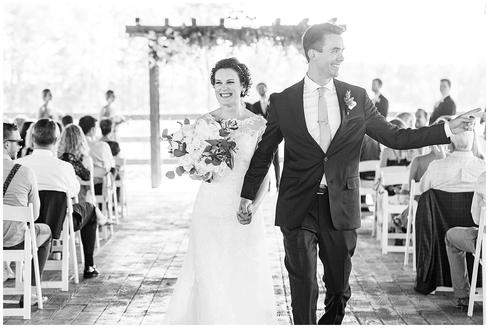 bride and groom exit summer wedding ceremony wave at guests