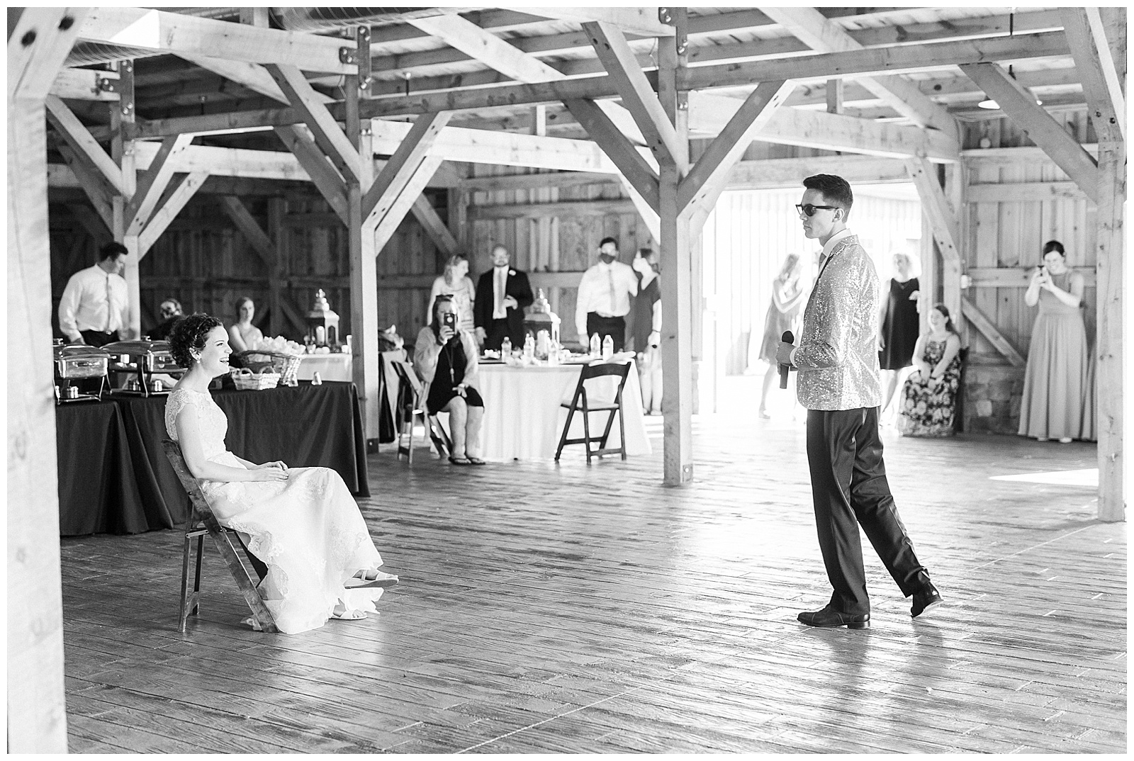 groom performs hilarious surprise song for bride in wooden open barn wedding venue