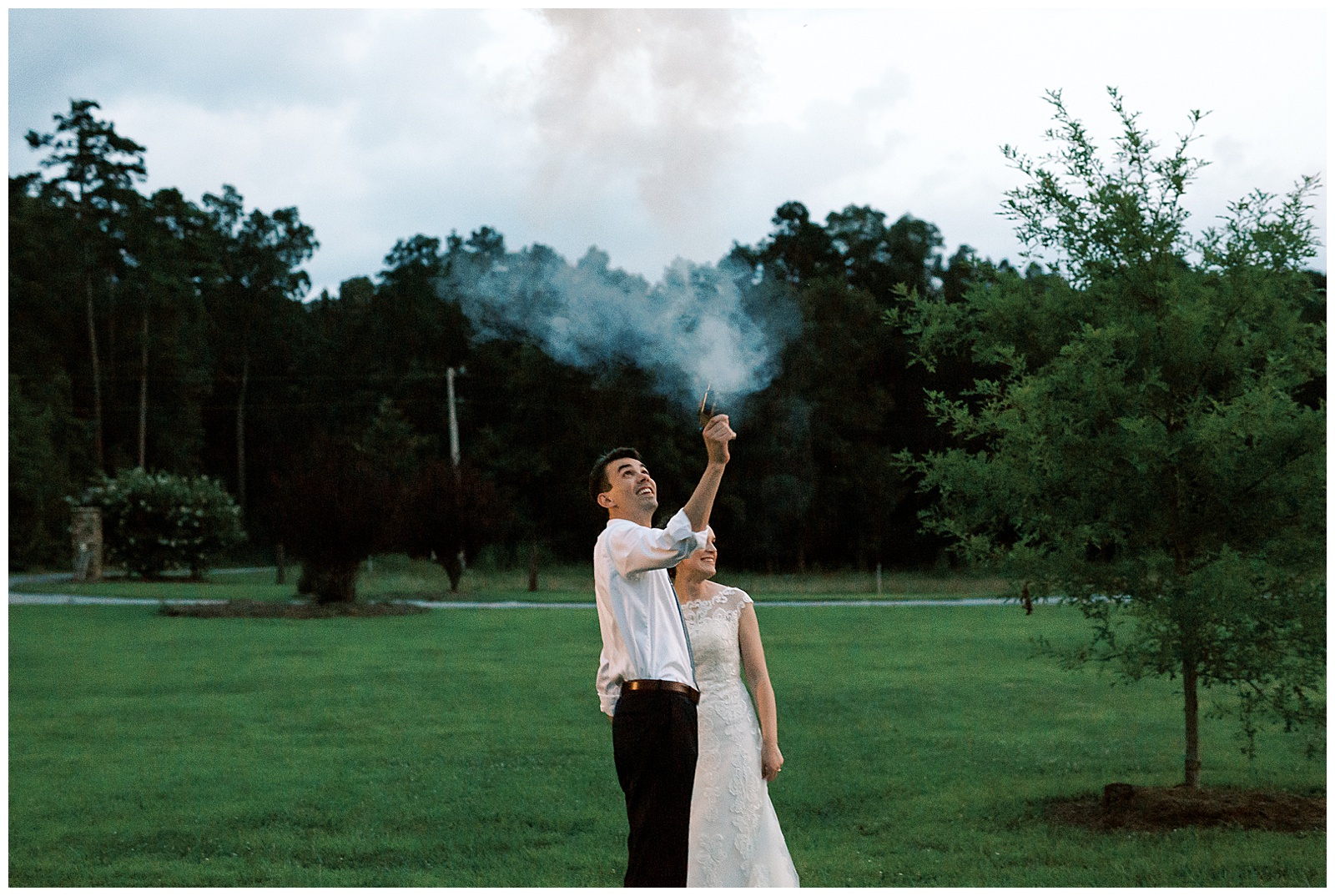 groom shoots off gun at outdoor wedding reception ceremony