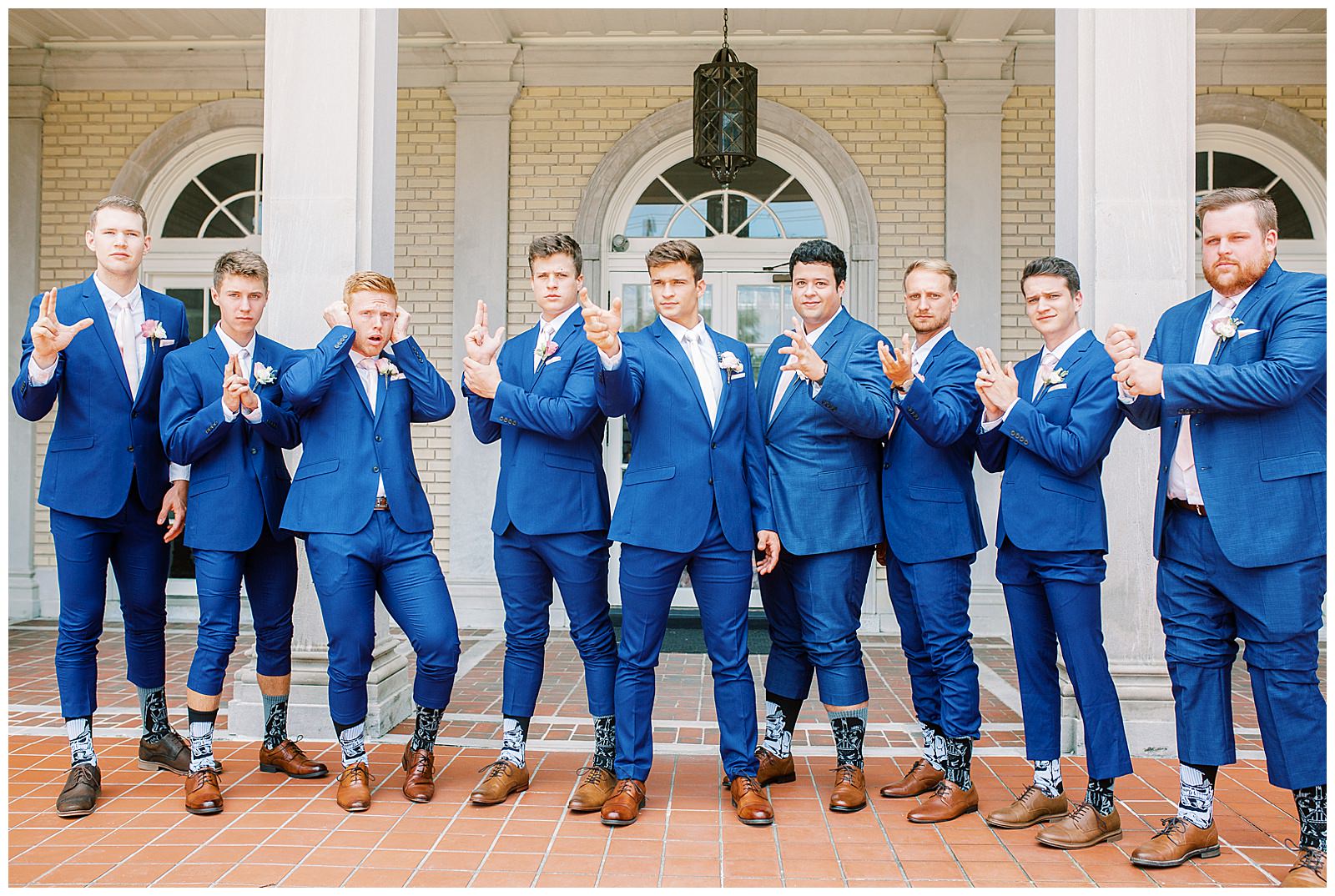dapper navy royal blue groomsmen style with pink ties outdoor guys group portrait
