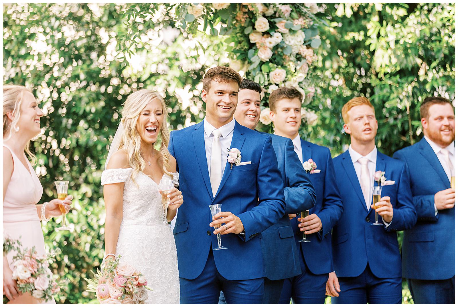 summer wedding toast outdoors at separk mansion with navy royal blue and soft pink bridal party