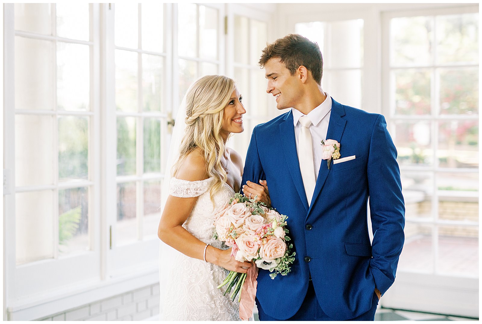 blond haired bride and dapper navy royal blue groom portraits in separk mansion black and white ballroom
