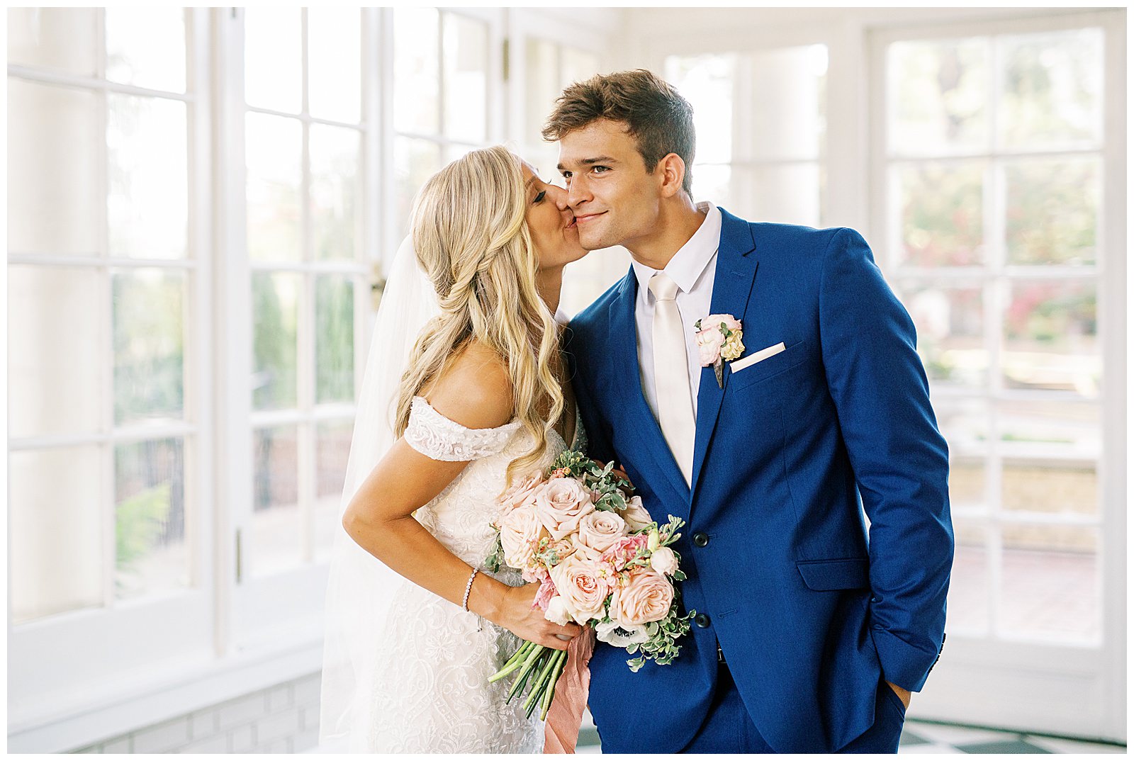blond haired bride and dapper navy royal blue groom portraits in separk mansion black and white ballroom