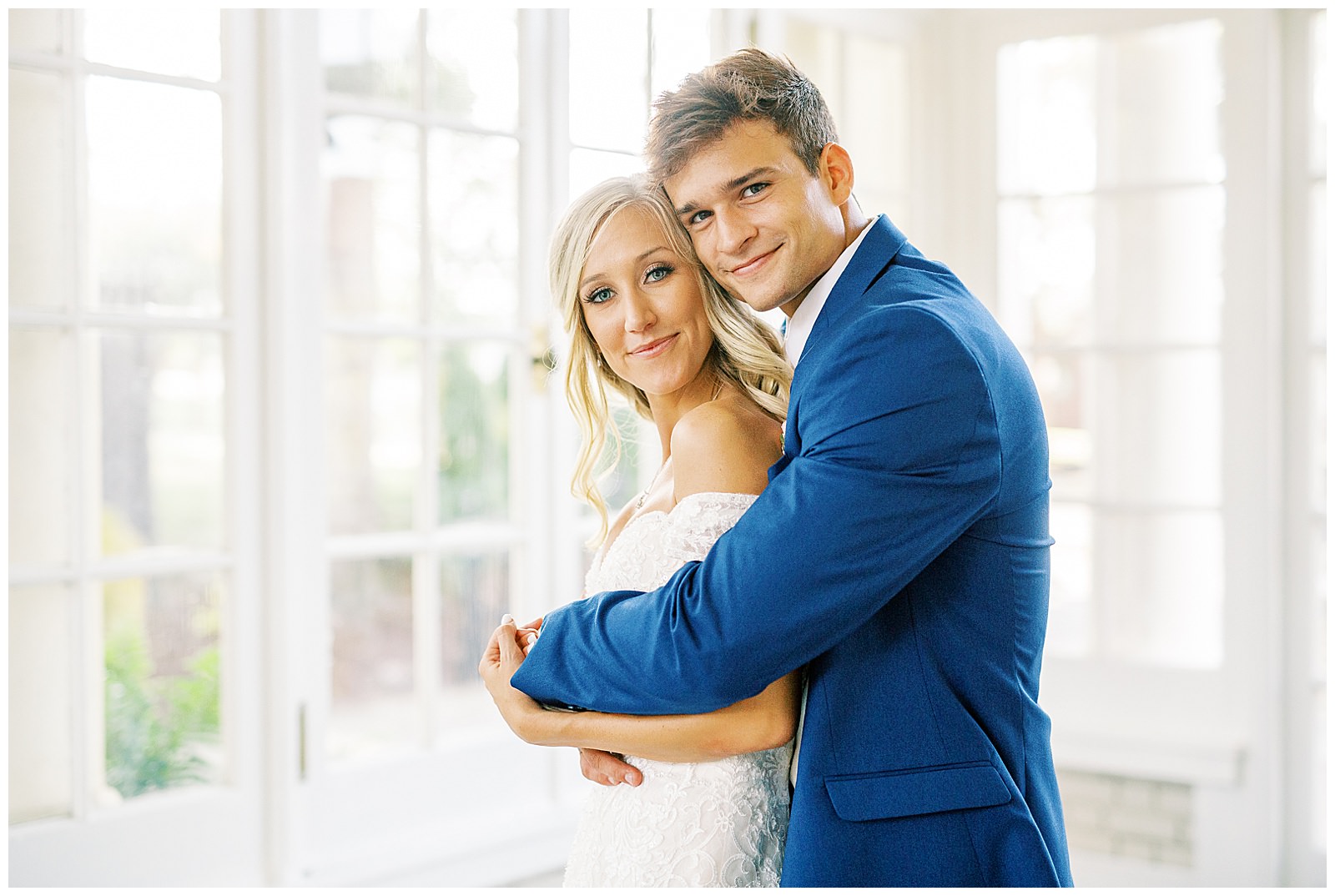 blond haired bride and dapper navy royal blue groom portraits in separk mansion black and white ballroom