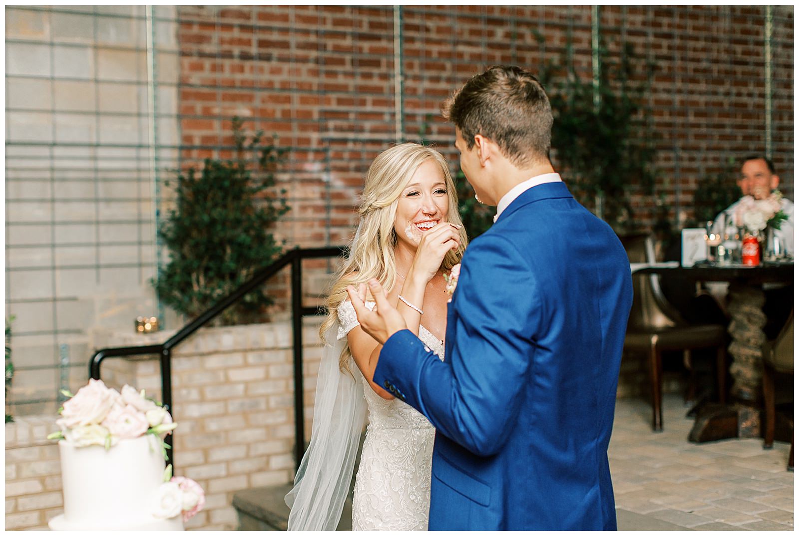 bride and groom cut floral wedding cake esquire hotel outdoor patio wedding reception