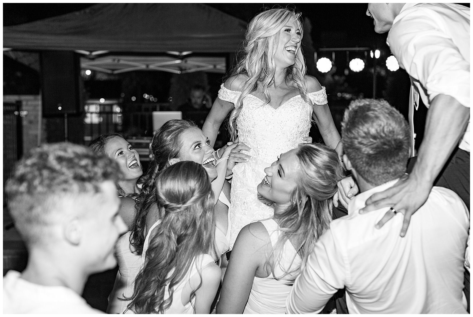 bride and groom crowd surf at esquire hotel outdoor patio wedding reception