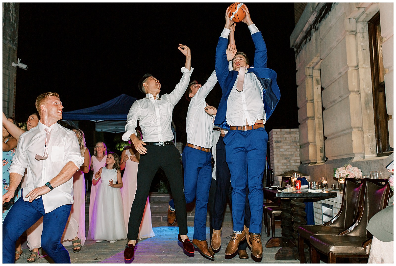 groomsmen catch garter on basketball at esquire hotel outdoor patio wedding reception