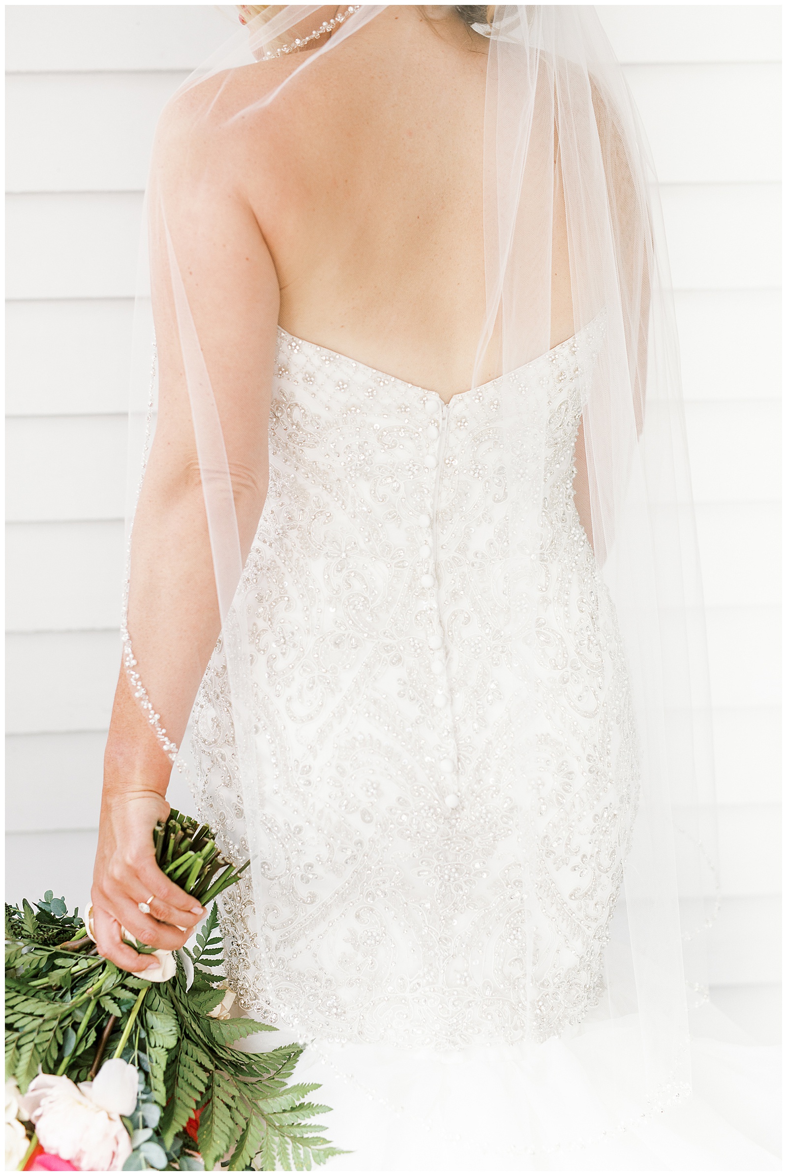 gorgeous light and airy outdoor bridal portraits of blonde haired bride in mermaid dress with loads of tulle on southern porch with red and white bouquet