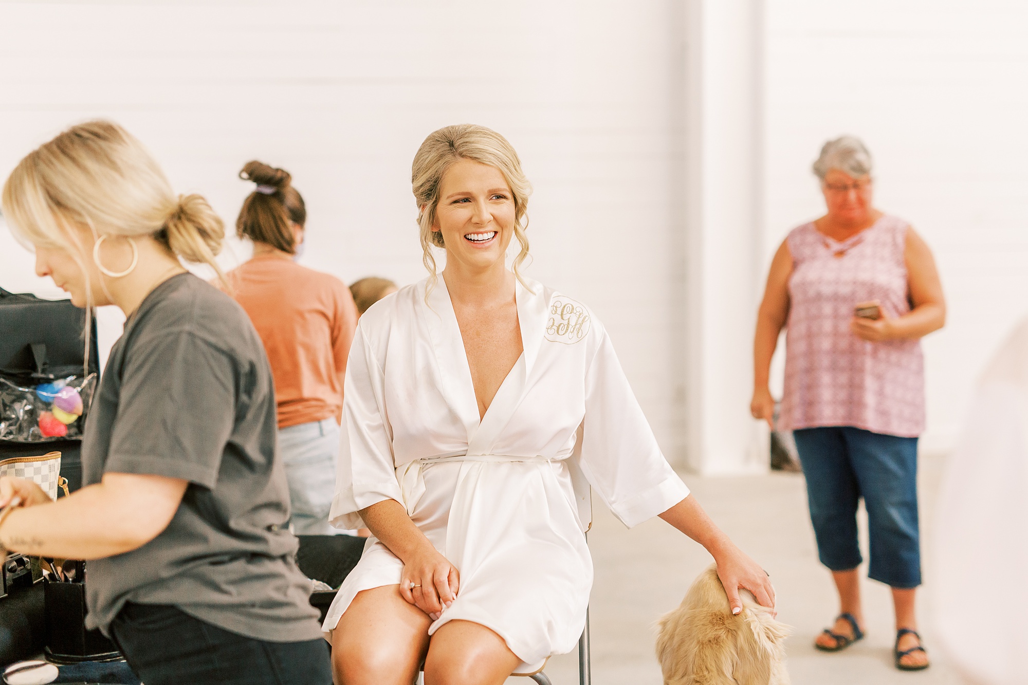 bride pets dog while getting ready for South Carolina wedding