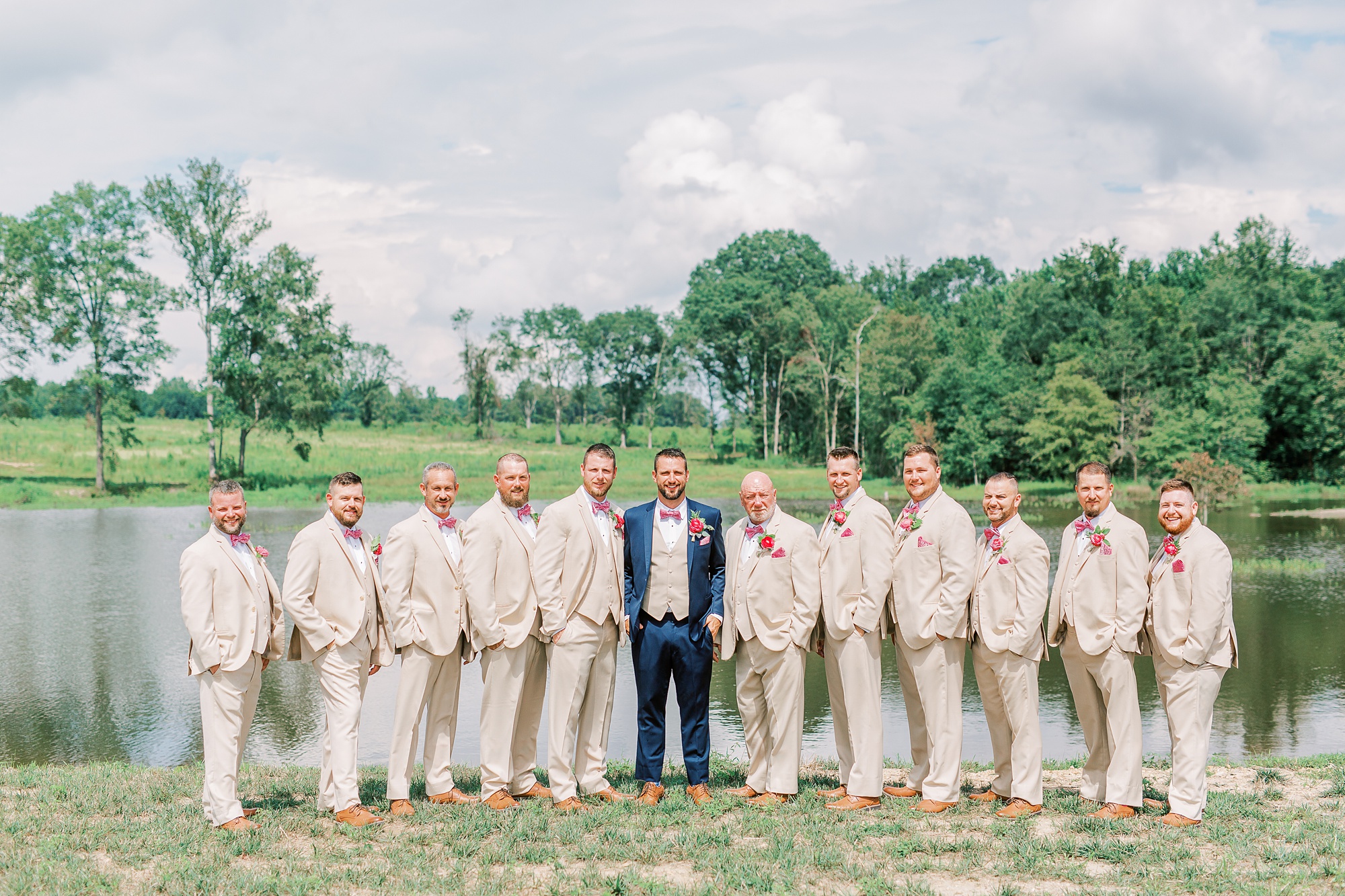 groomsmen in tan suits pose with groom at Belle's Venue
