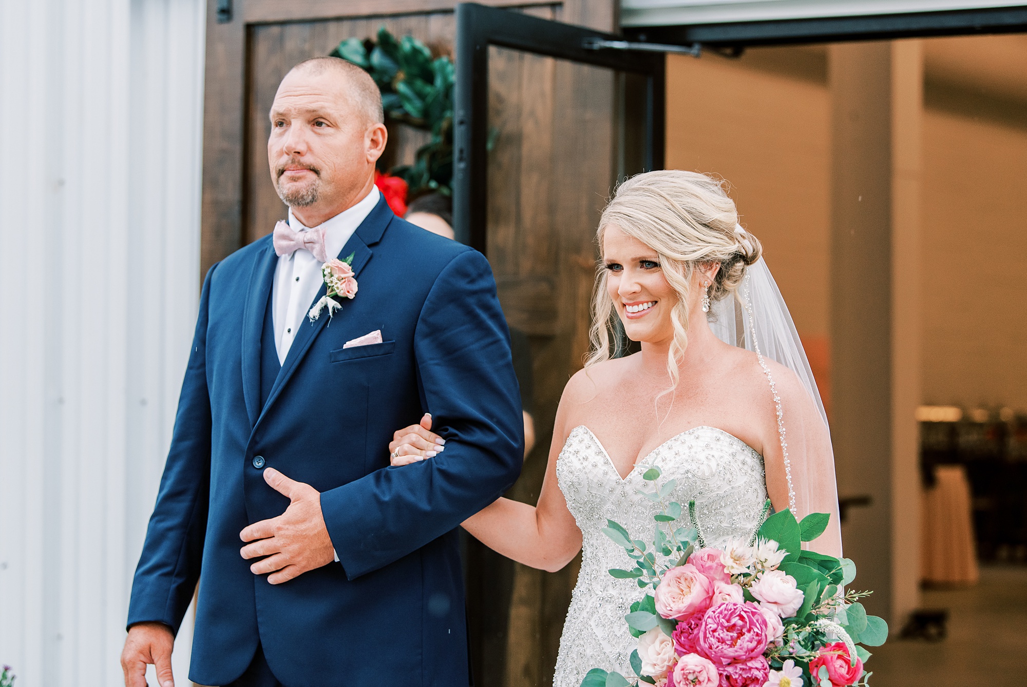 bride walks down aisle with dad