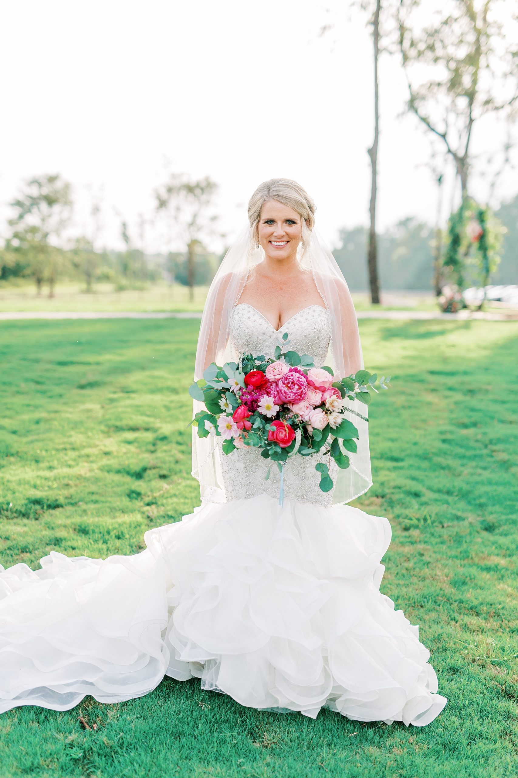 bride holds bouquet of flowers at Belle's Venue