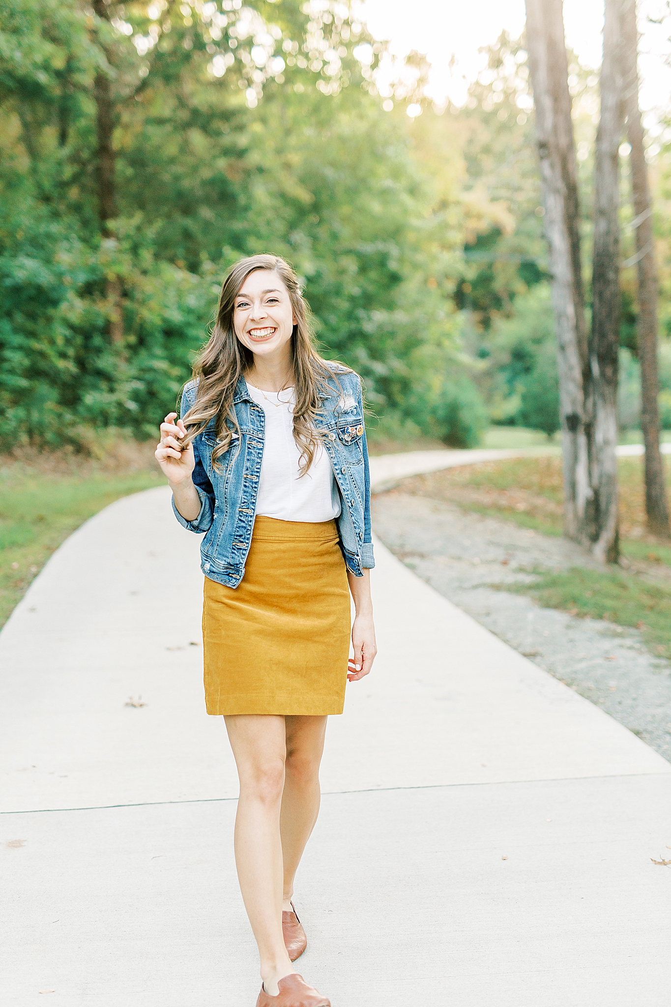 woman laughs twirling hair during Charlotte NC family photos