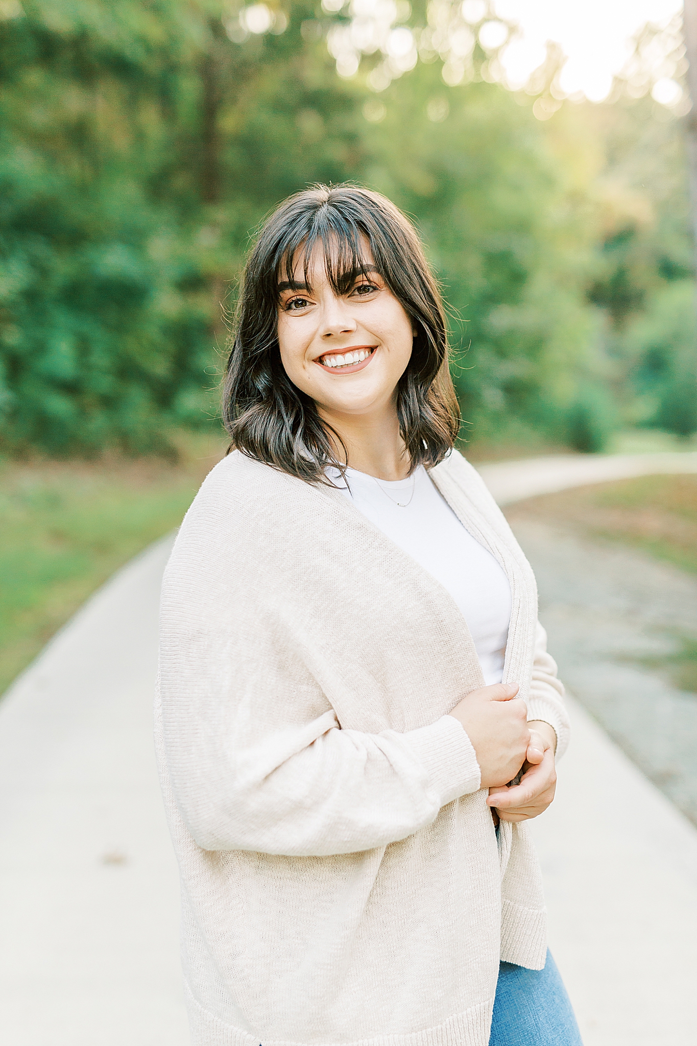 portrait of young woman in cream sweater