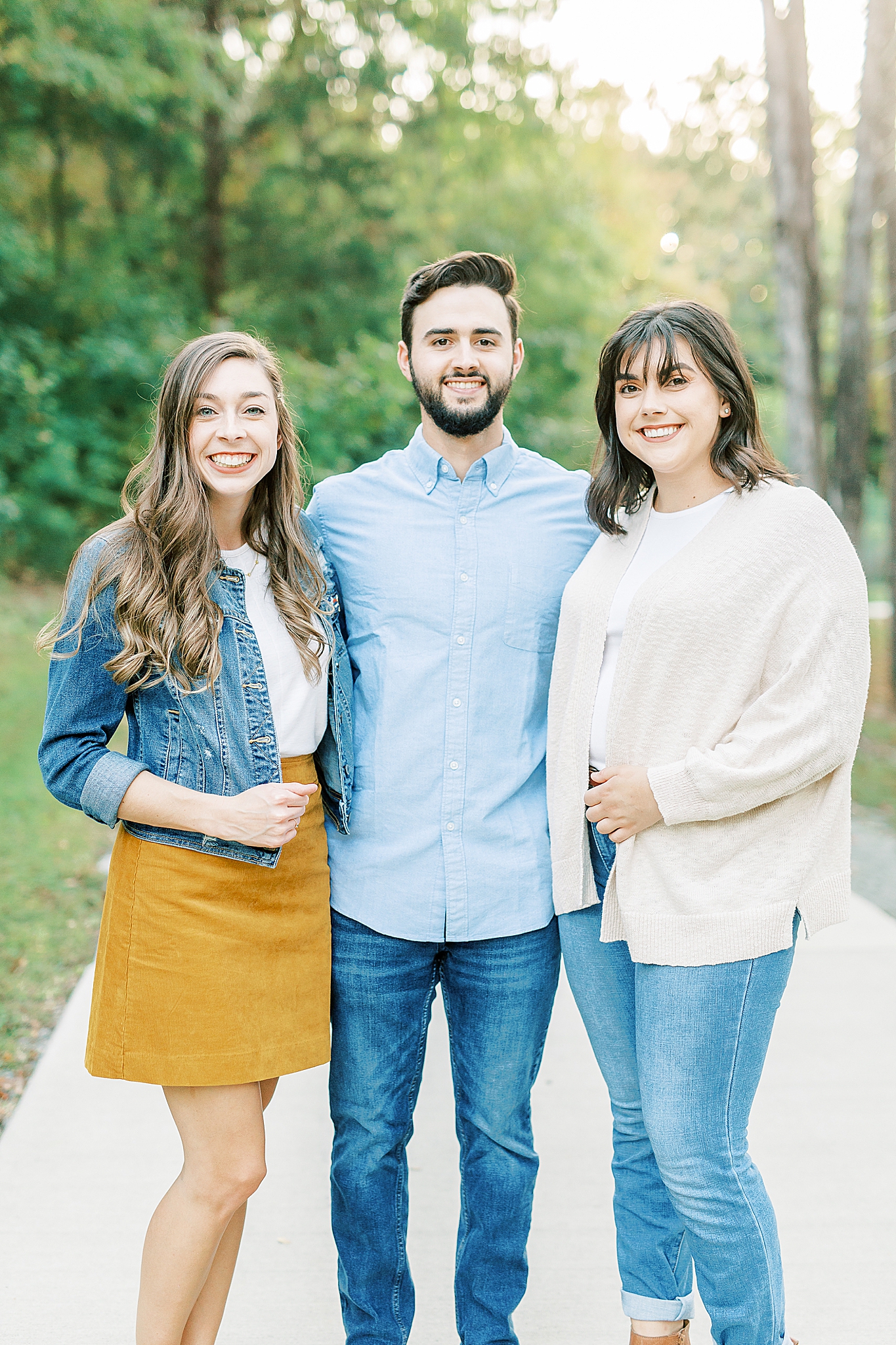 sisters pose with brother-in-law during Charlotte Fall Family Portraits