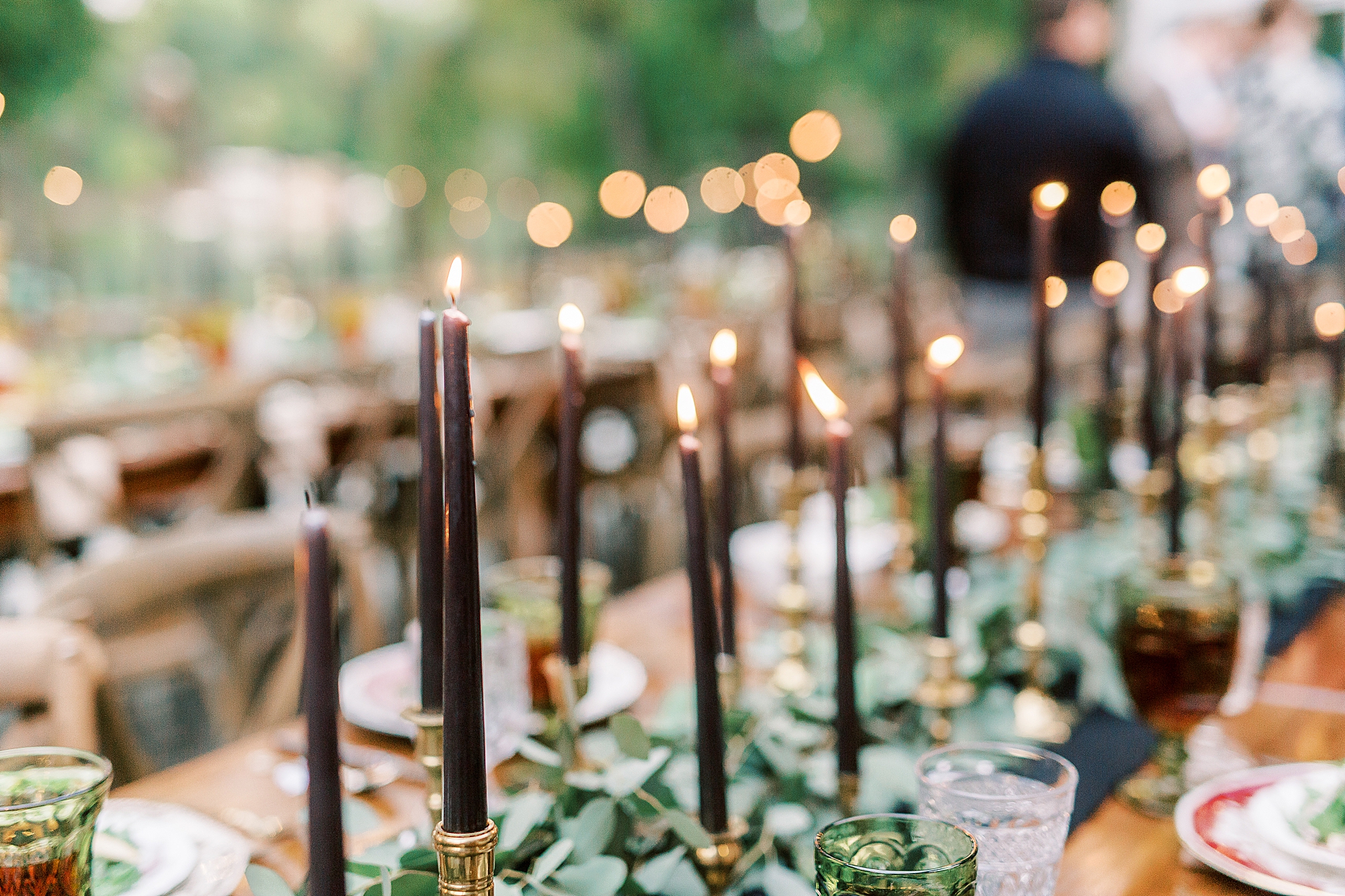 candles lit for backyard wedding rehearsal dinner