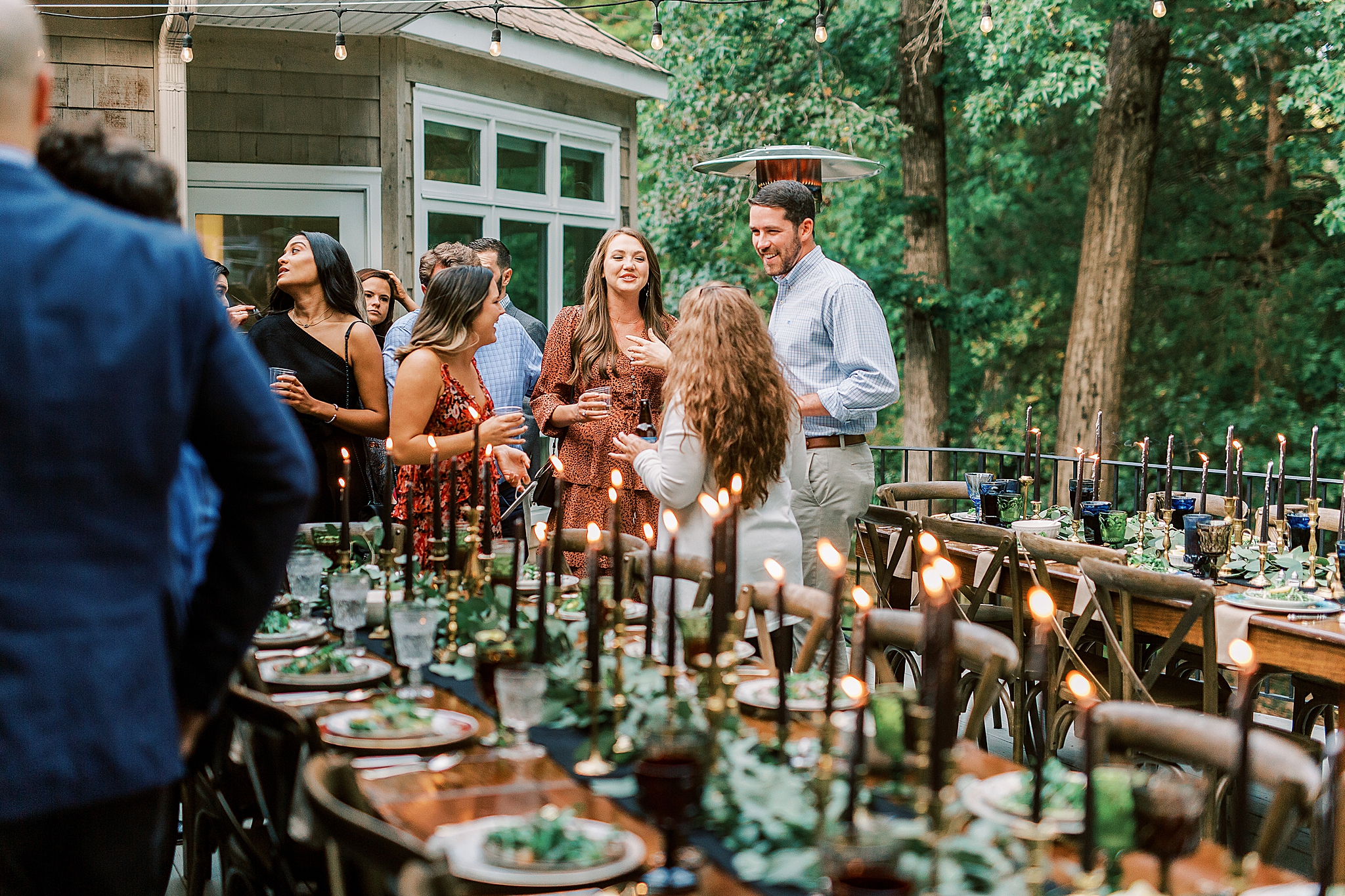 wedding guests mingle during backyard welcome dinner