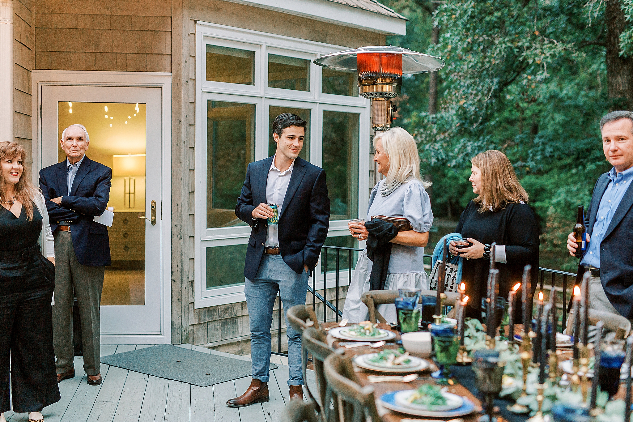 groom talks to guests during rehearsal dinner