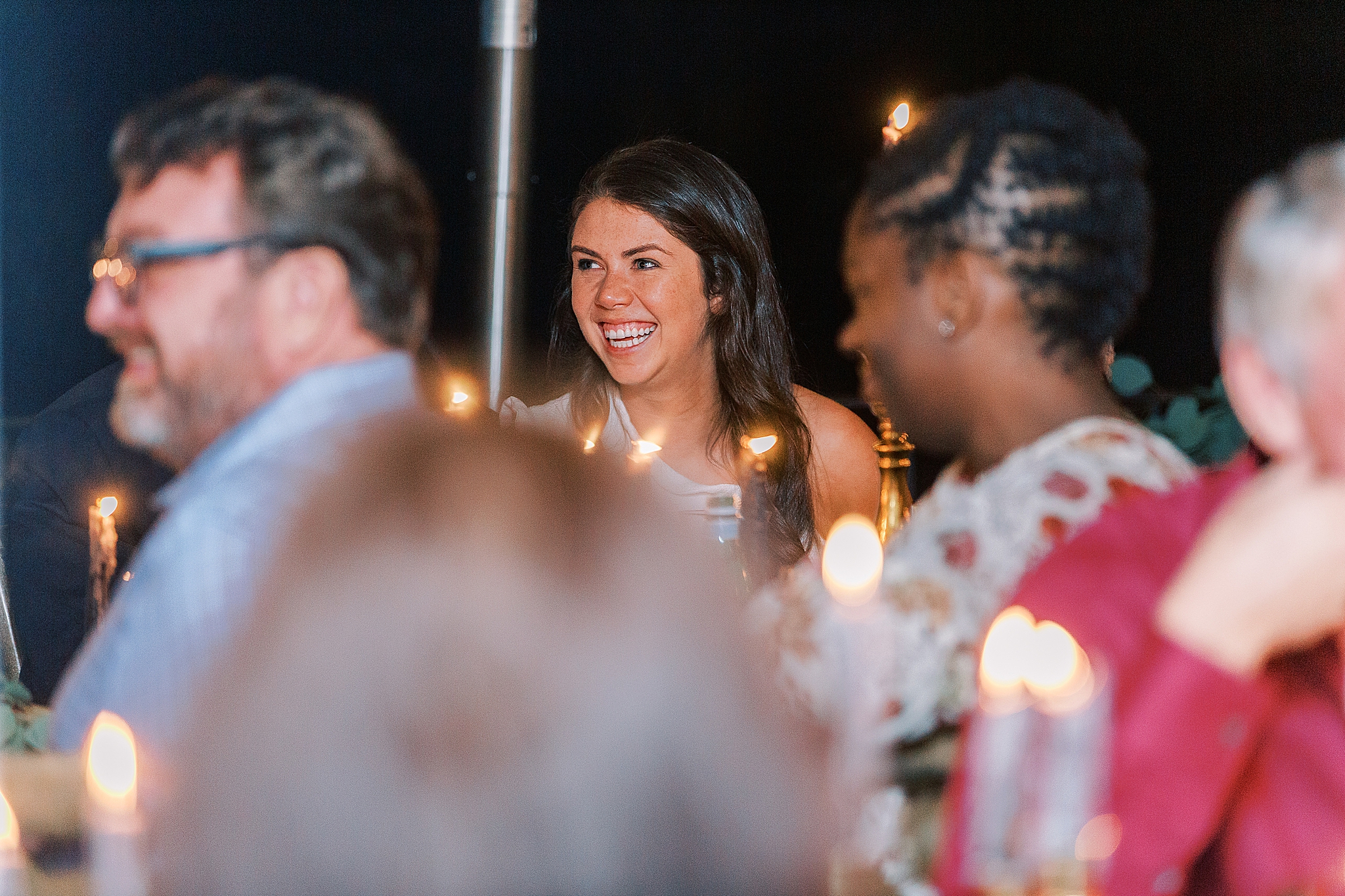 bride laughs during wedding toasts