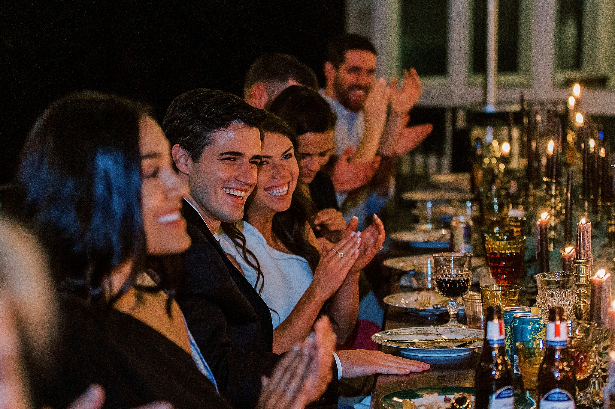 bride and groom clap during toasts
