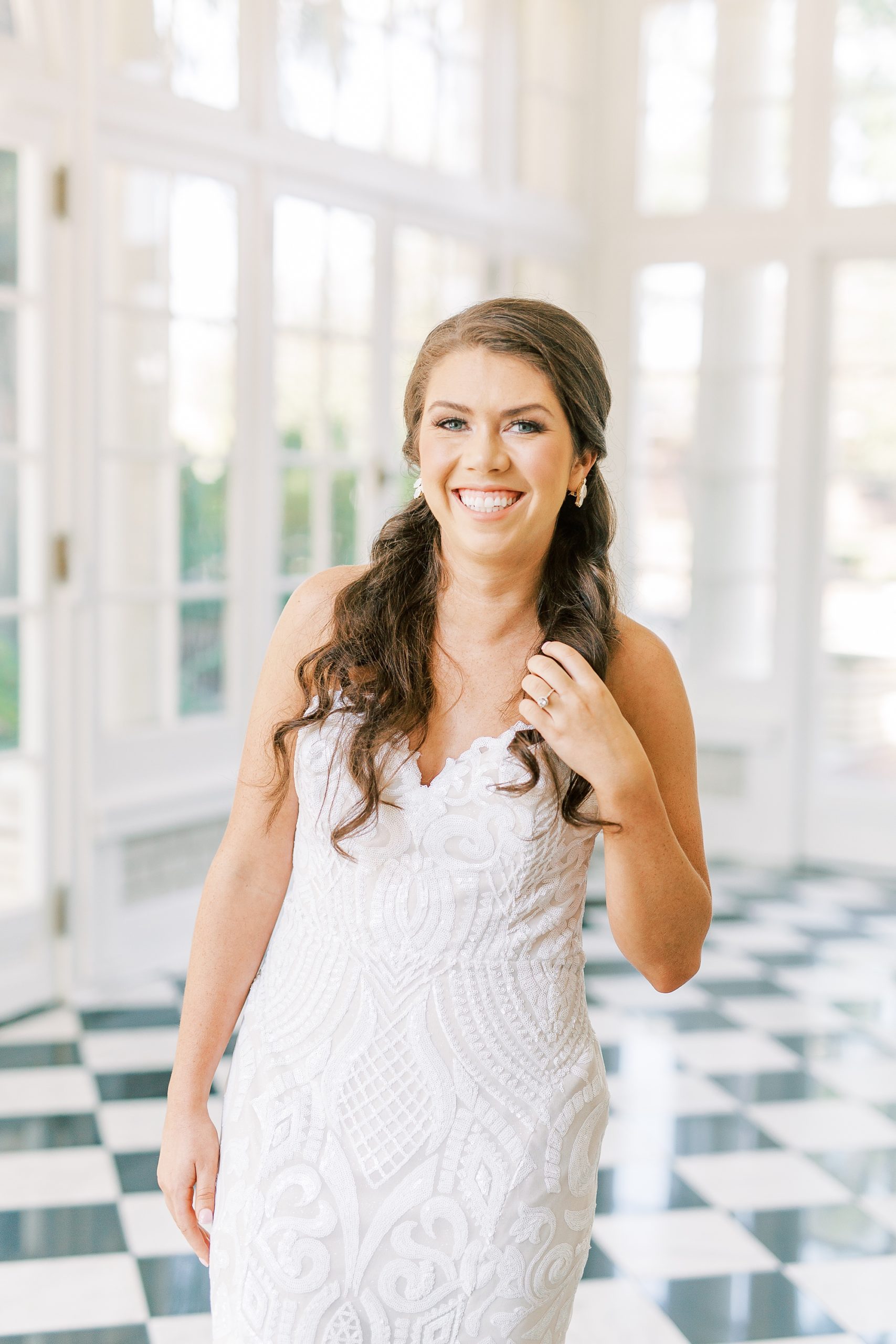 bride holds hair and laughs