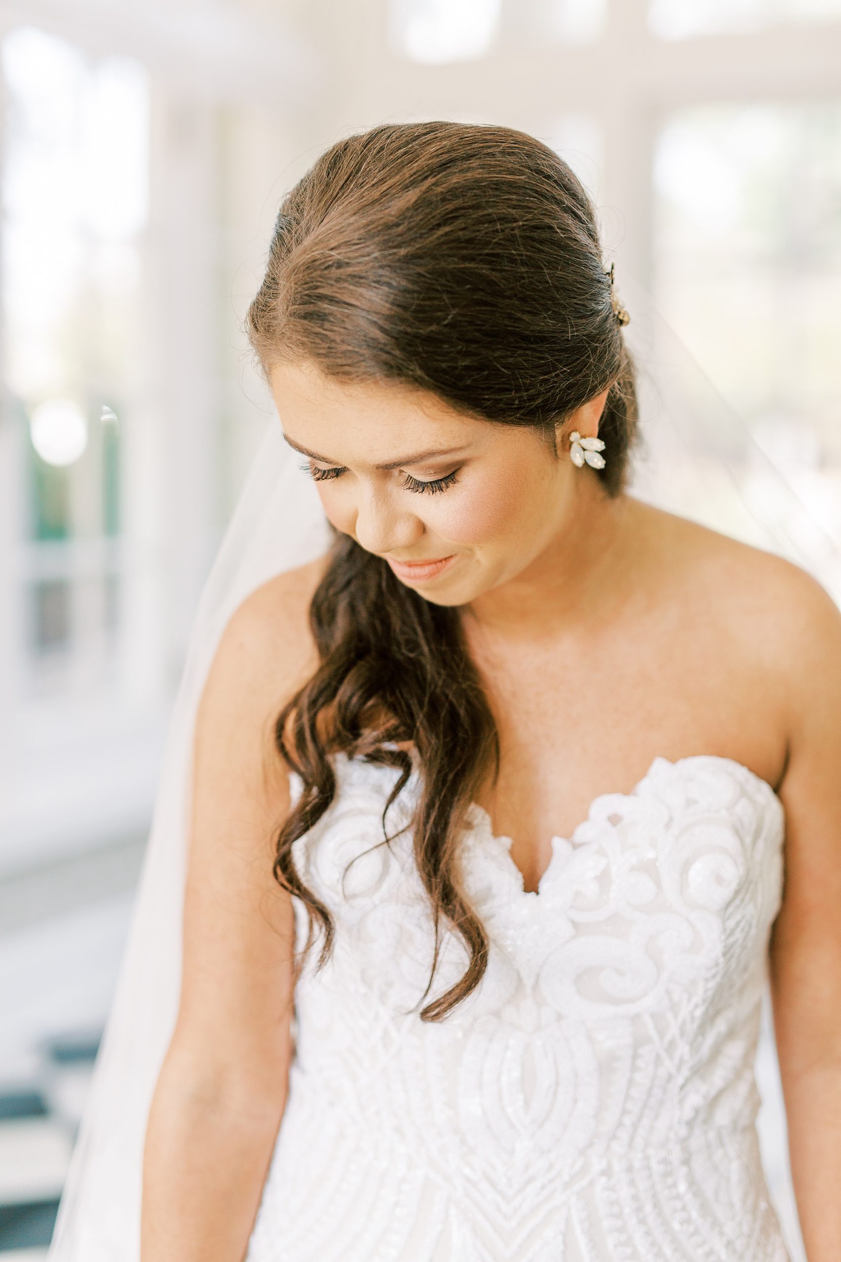 bride looks down over shoulder during CLT bridal session