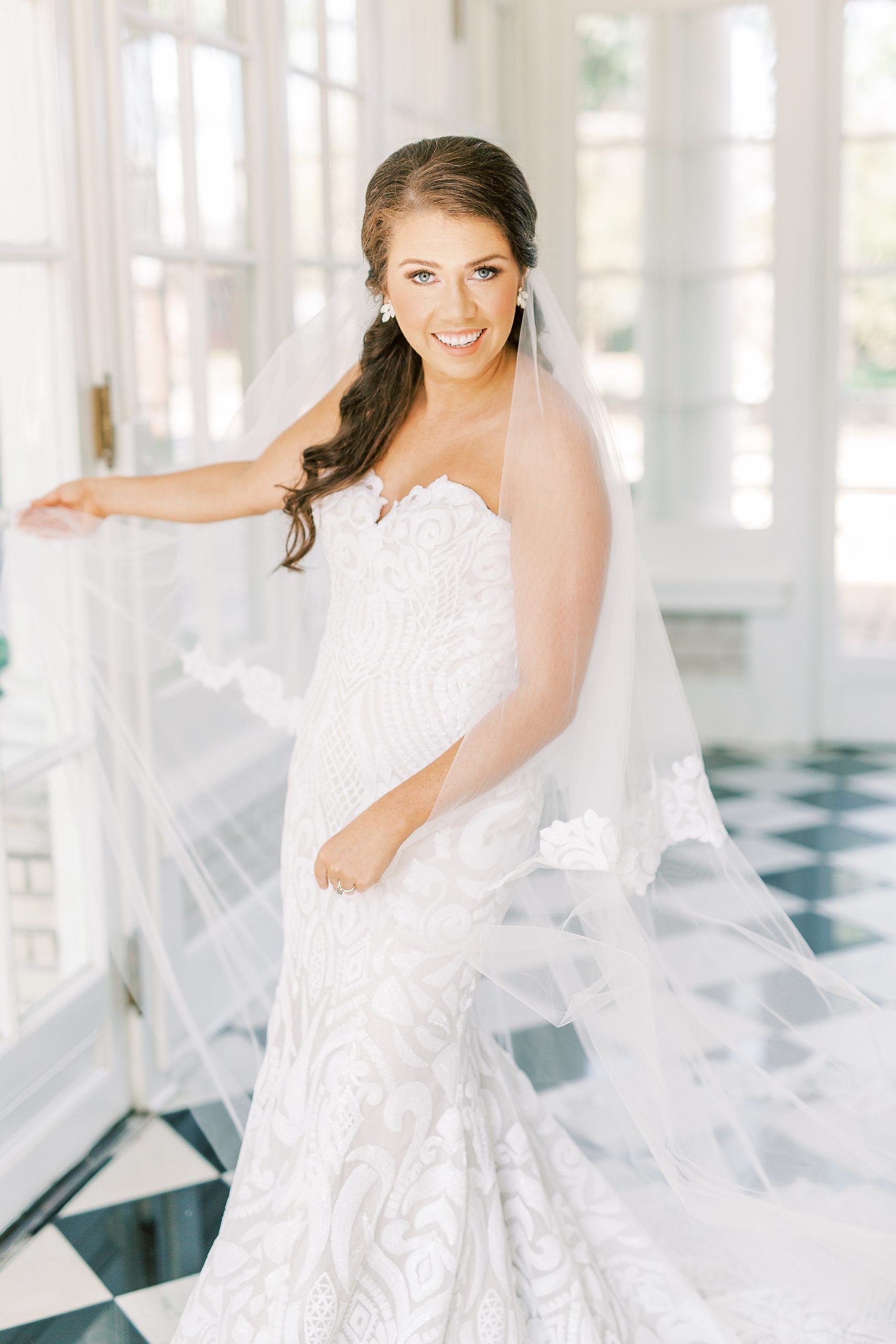 bride twirls in wedding dress with veil