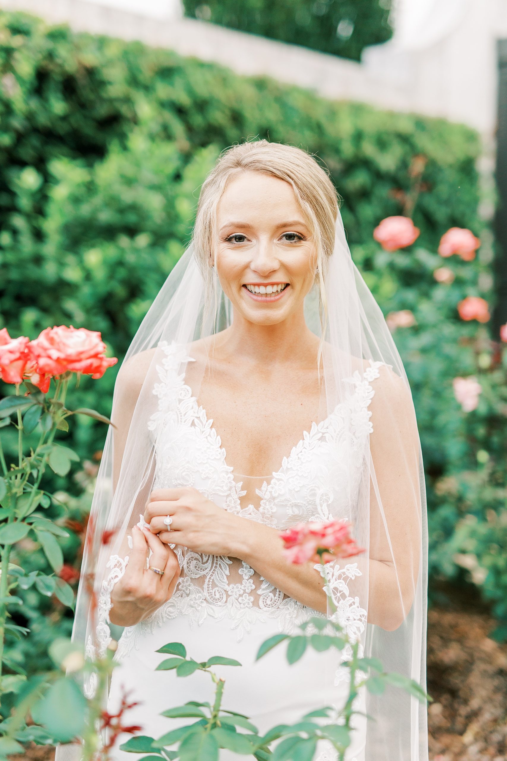 bride holds edge of veil during bridal portraits