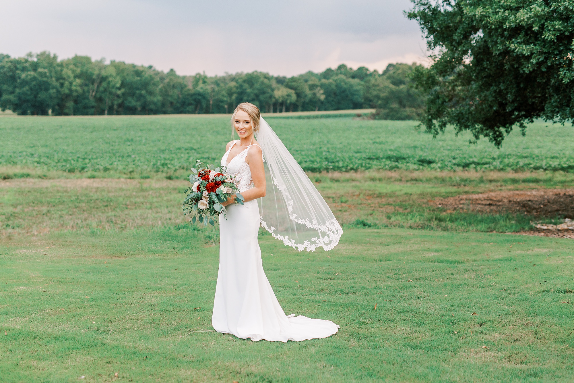 bride poses with veil floating during bridal session