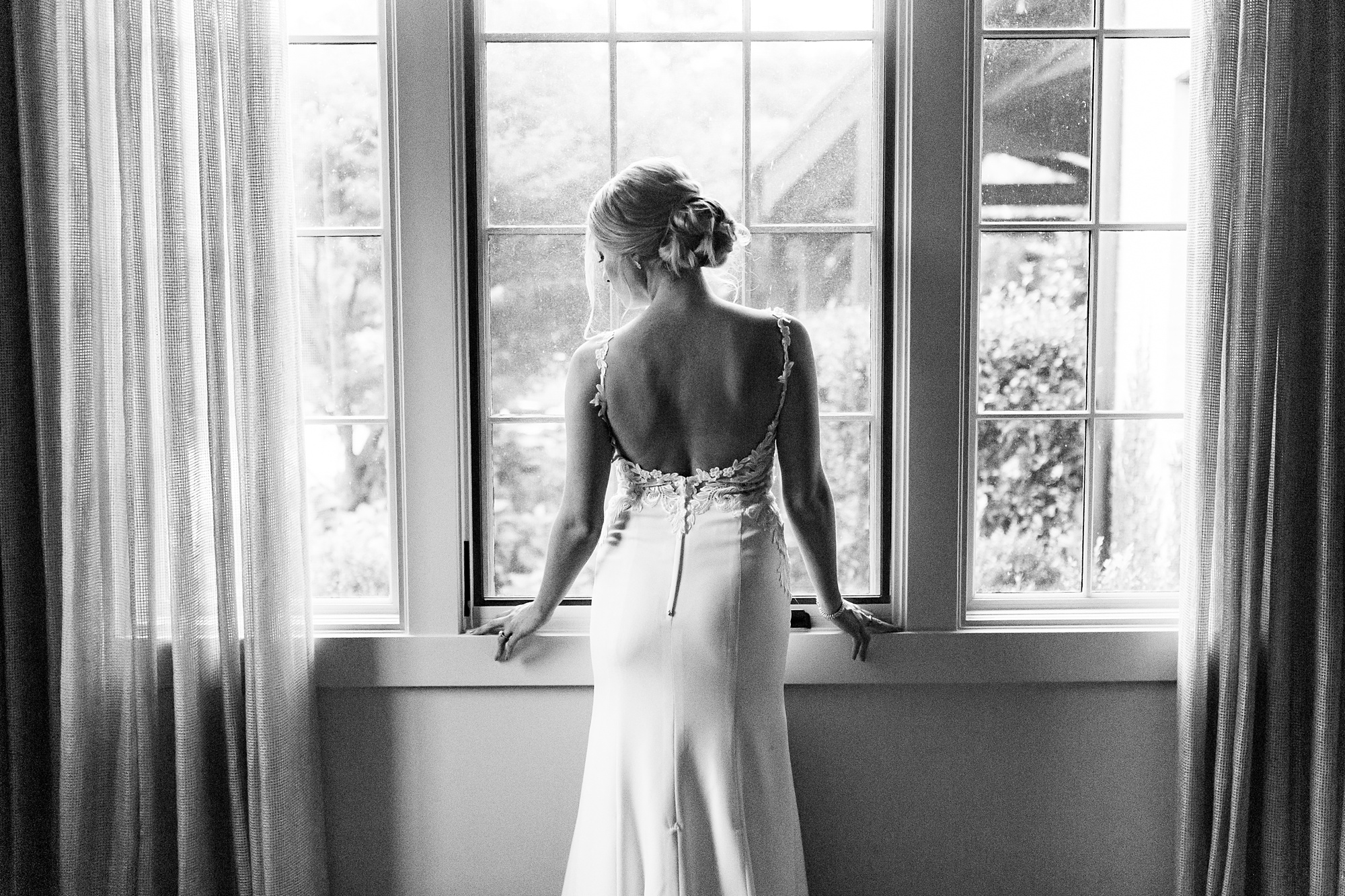 bride stands facing window at The Andrews Farm
