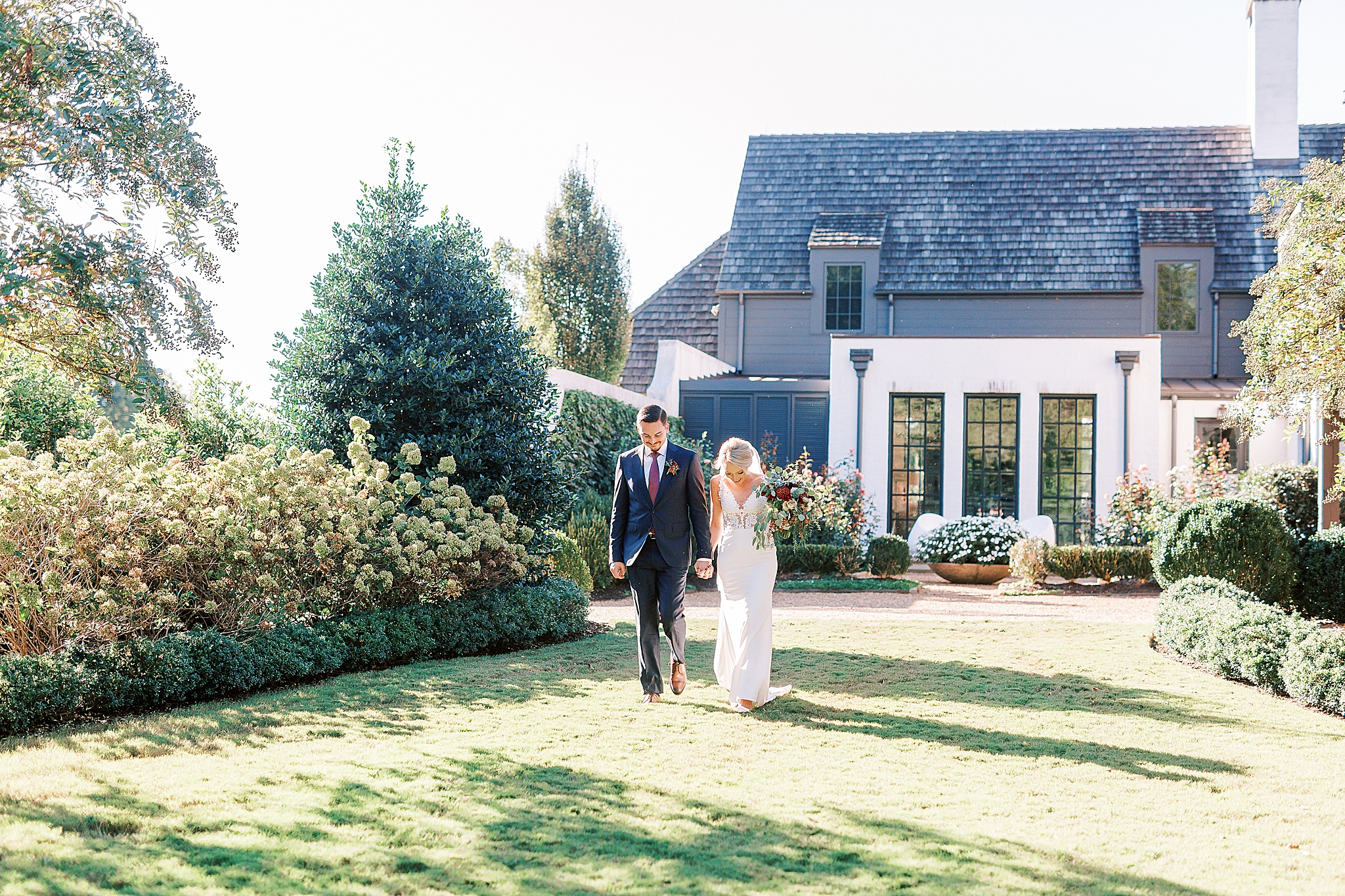 engaged couple walks to wedding ceremony on The Andrews Farm