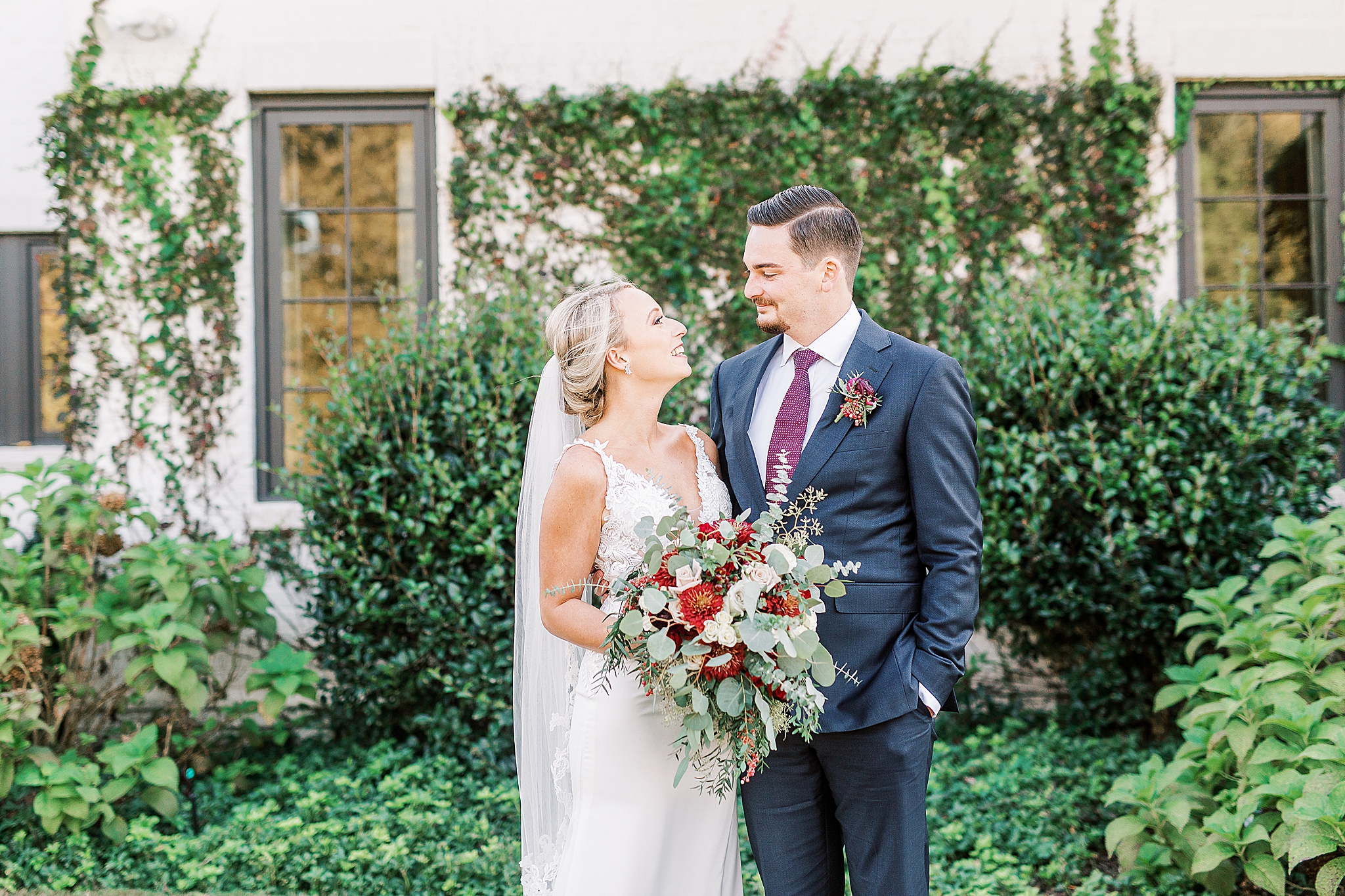 bride and groom look at each other during wedding photos