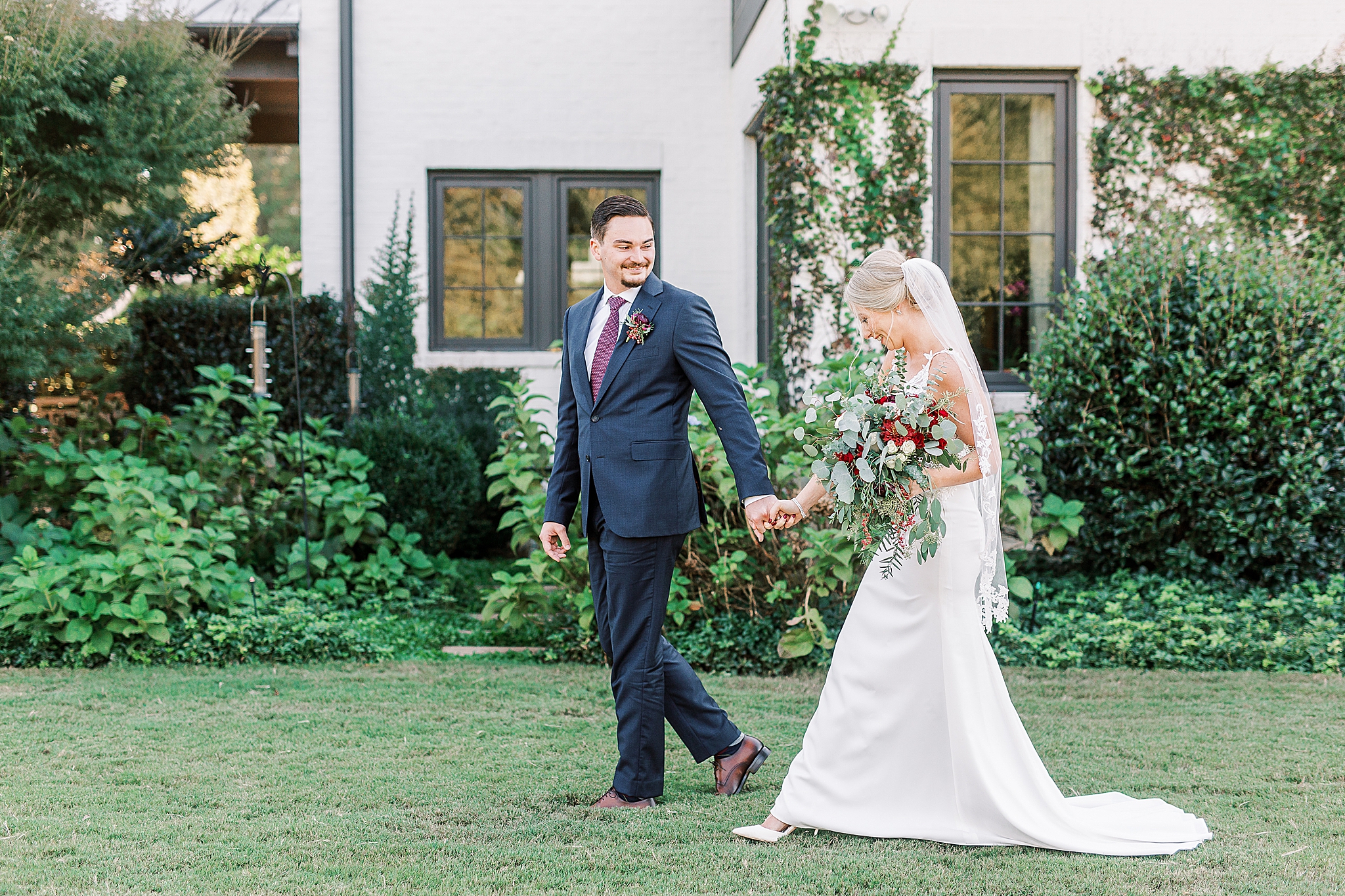 bride and groom walk through The Andrews Farm after eloping