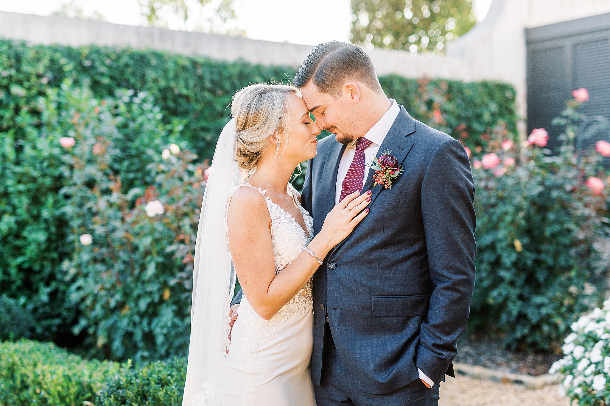 bride and groom stand nose to nose during NC wedding portraits