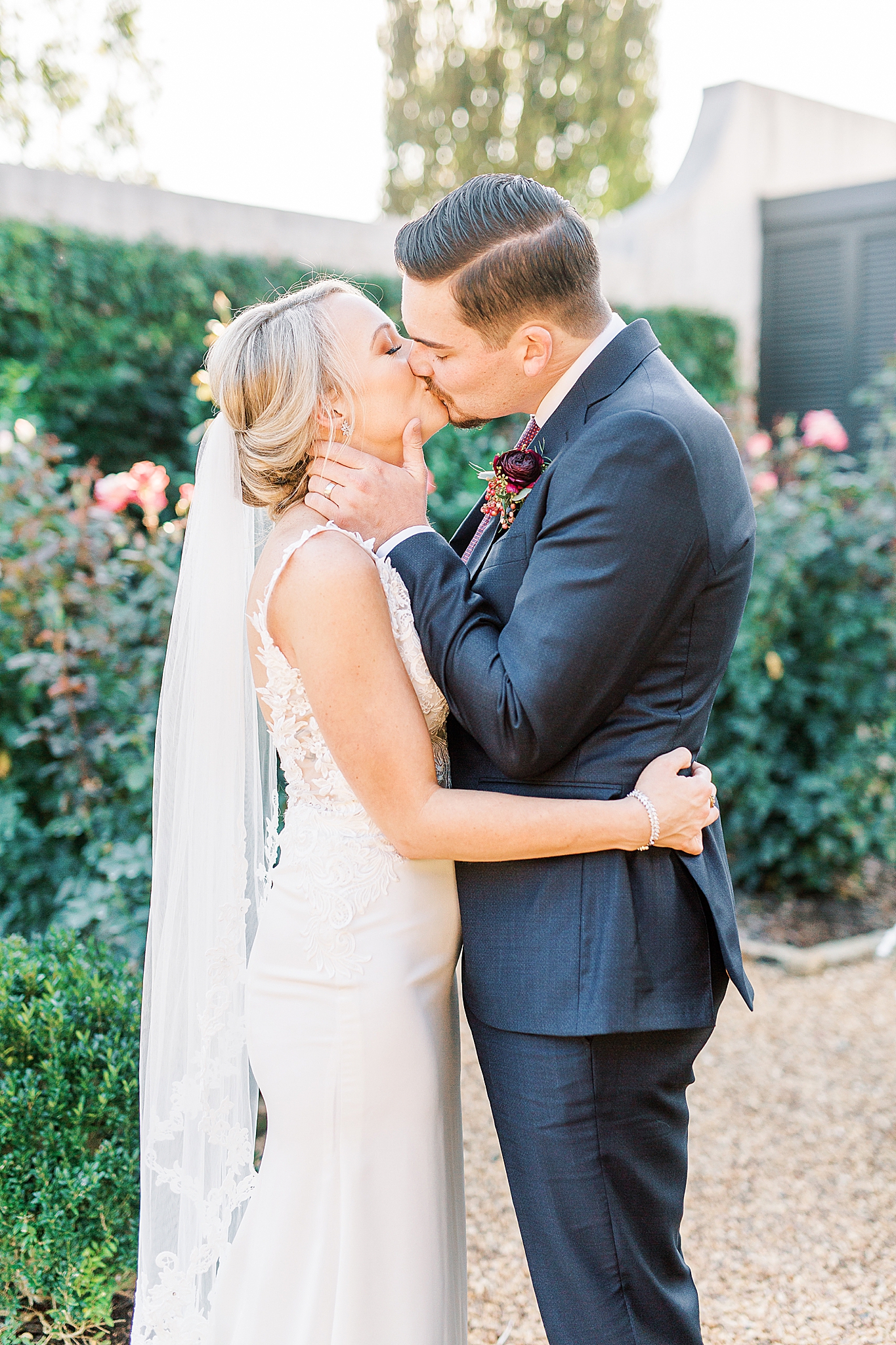 groom kisses bride in Andrews Farm garden