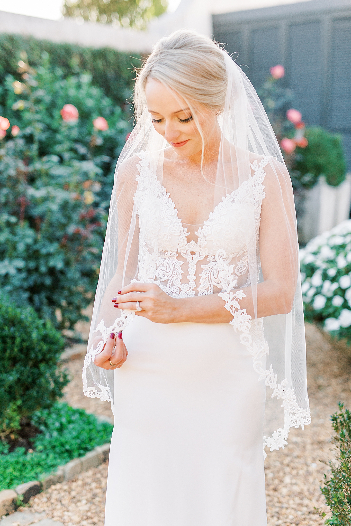 bride looks down at veil during NC elopement portraits
