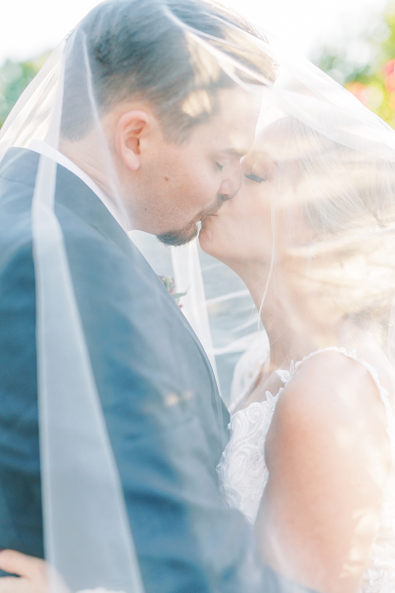 newlyweds kiss under bride's veil