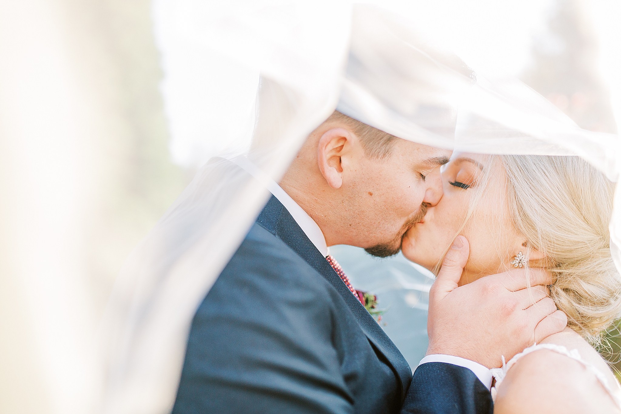 newlyweds kiss under bride's veil