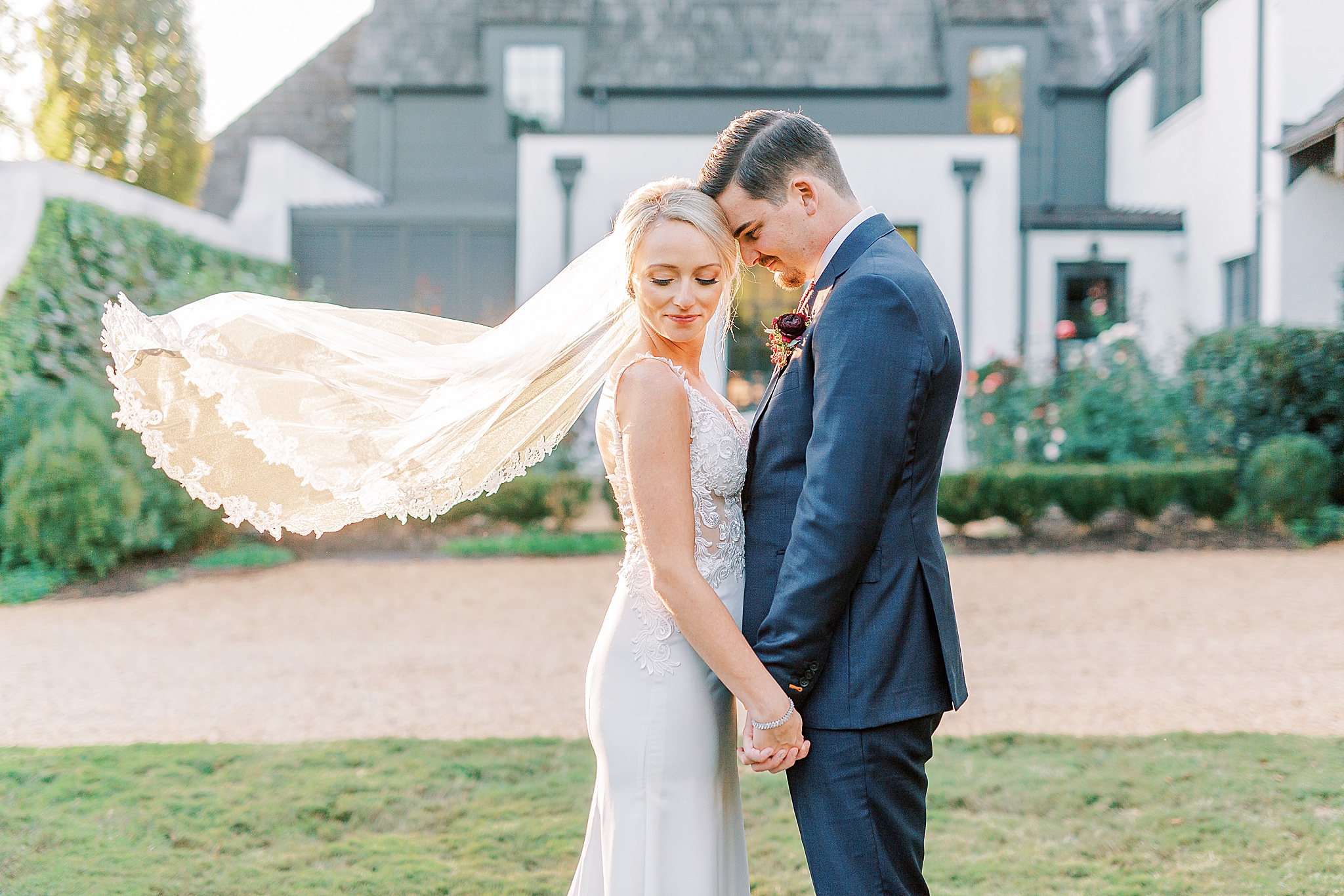 groom leans against bride's head at The Andrews Farm