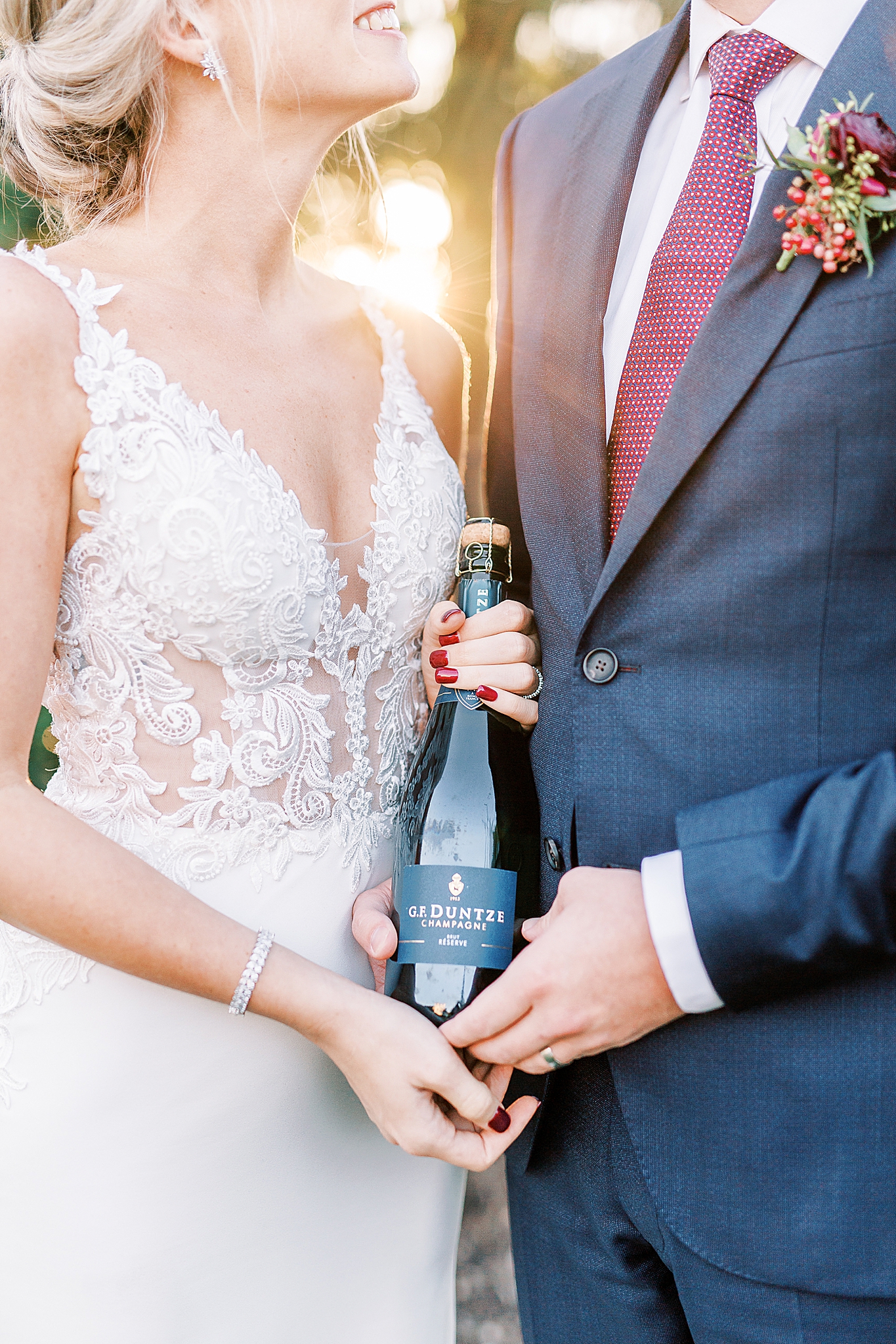 bride and groom hold champagne after eloping