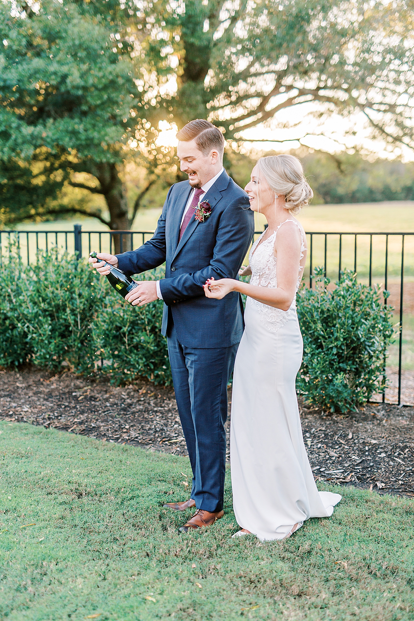 bride laughs as groom pops champagne