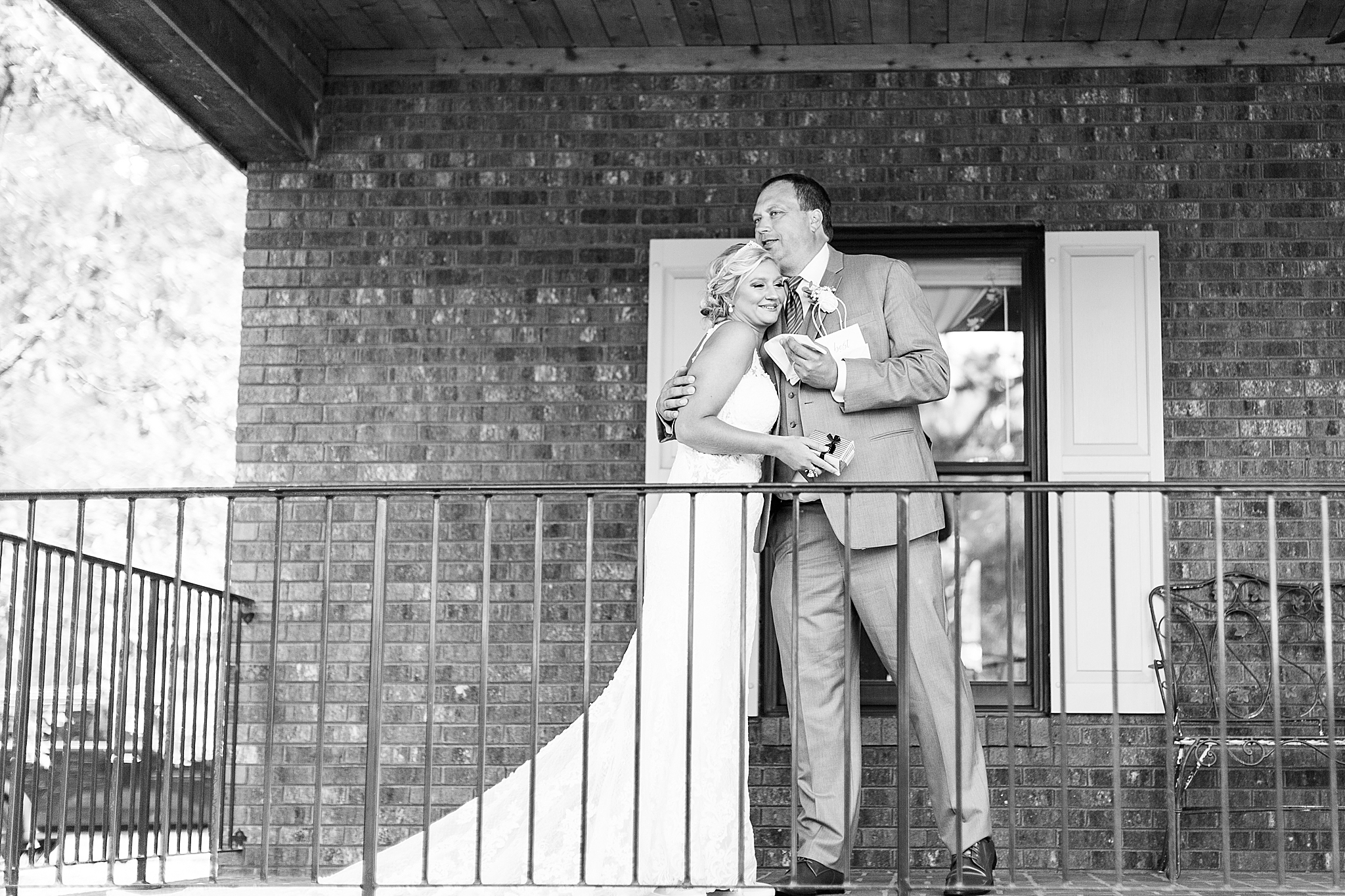 dad kisses bride during first look on porch