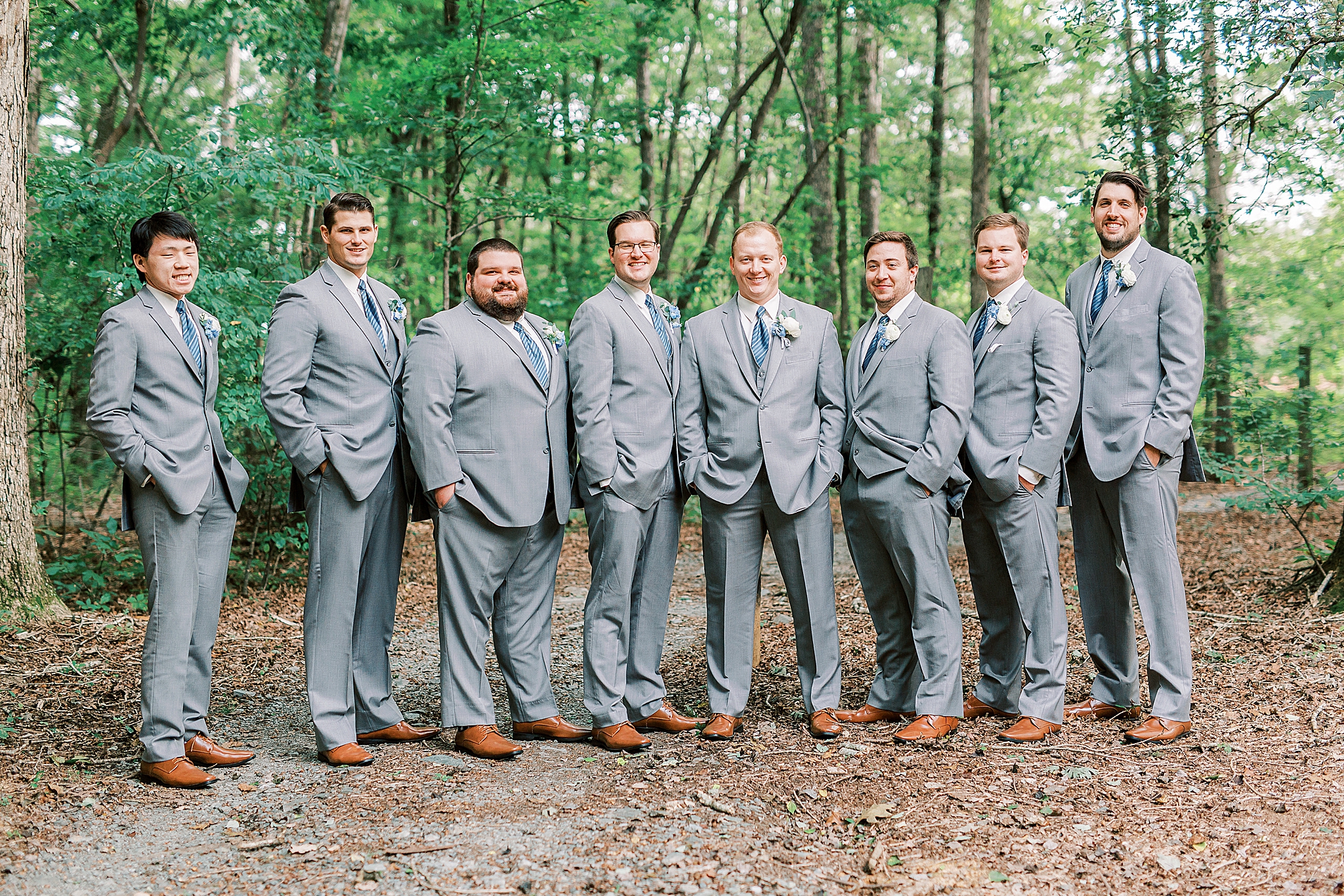 groom and groomsmen in grey suits pose before The Farm at Brusharbor wedding