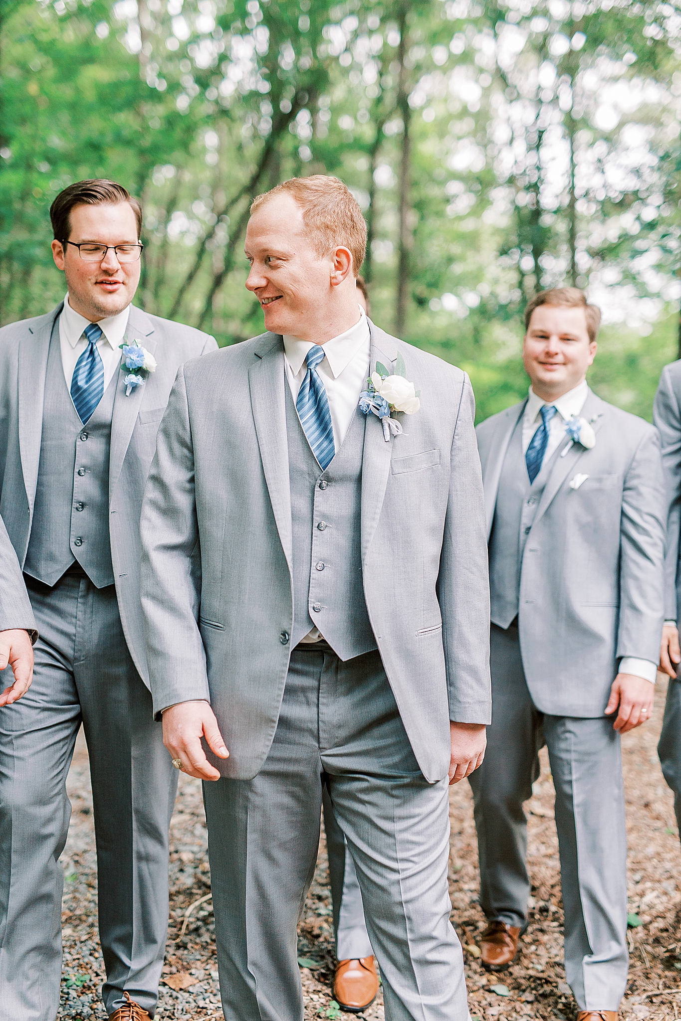 groom walks with groomsmen before wedding ceremony