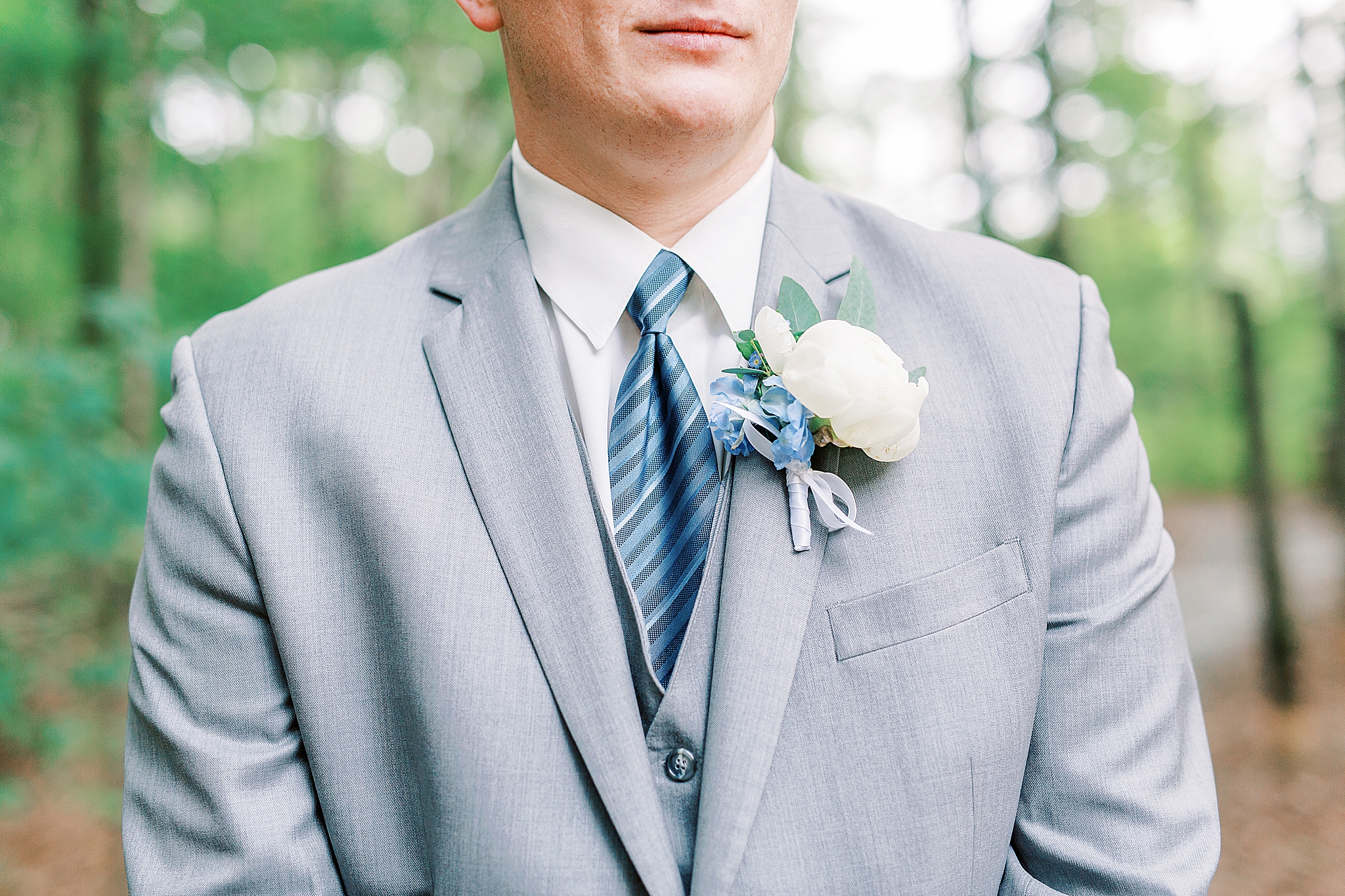 groom in grey suit with blue tie