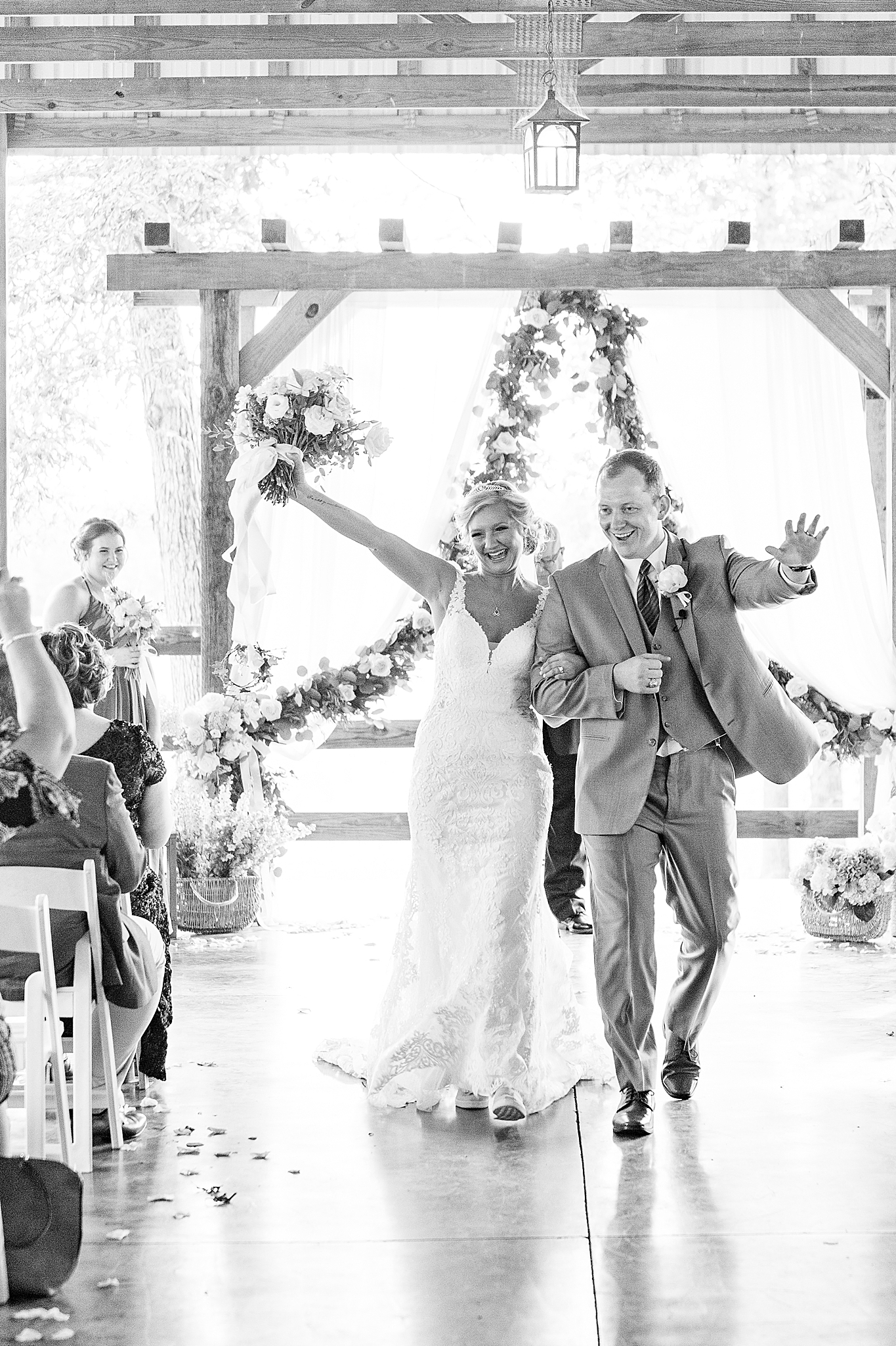 newlyweds cheer walking up aisle at The Farm at Brusharbor